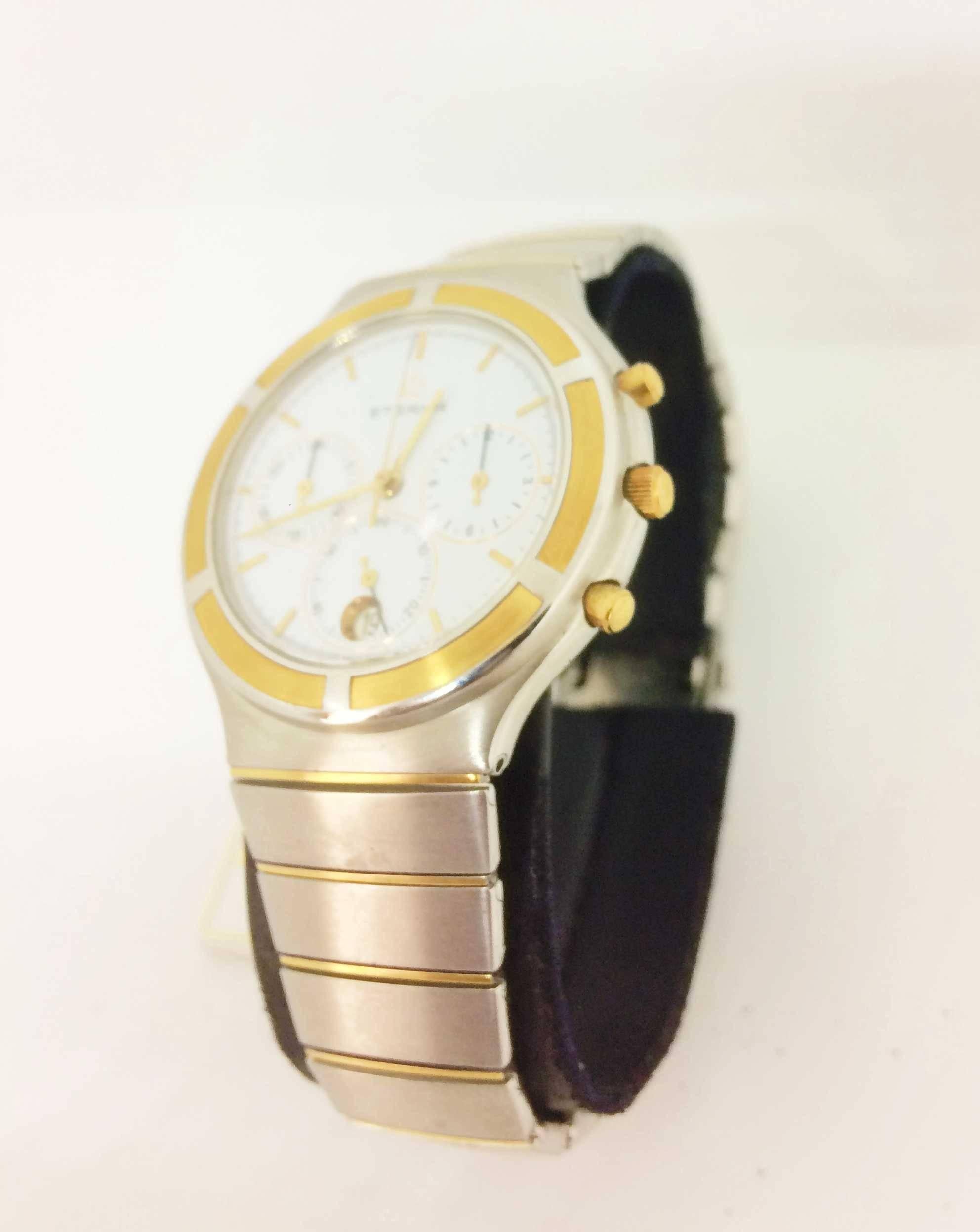 Gold and Steel
Gold and Steel Bracelet 

White Dial 
Gold and Steel Bezel 
3 counters
Date at 6 o'clock

Moon Phase

High resolution quartz

New battery
New stock

1 year warranty