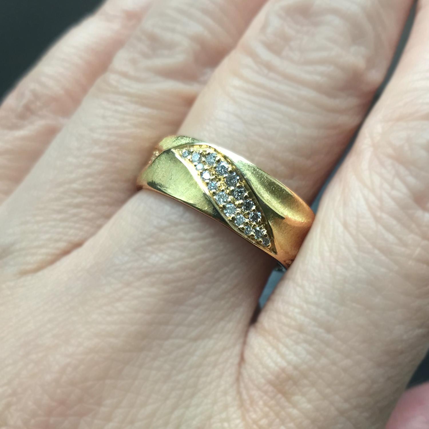 Diamonds (0.51ct total weight) wrap around K.Mita’s Eternal Dune Band in a twisting pattern accentuated by her “dune” texture that seemingly continues forever. The ring is made from 18k yellow gold and is 6.5mm wide. Handmade to order in 10-14 days.