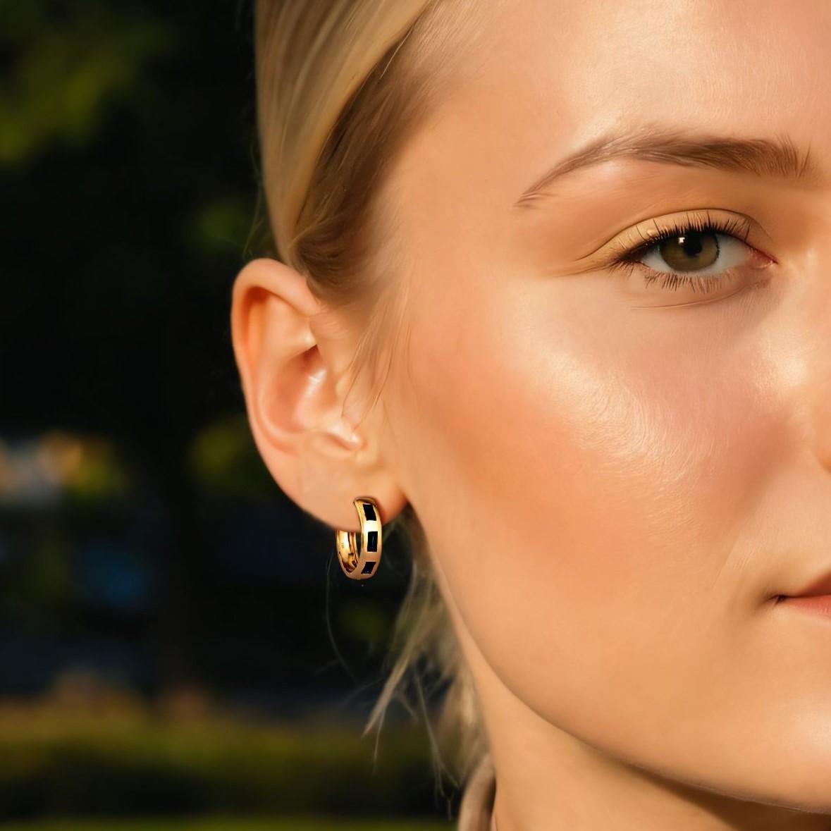 The Eternal Gemstone 14K Yellow Gold Huggies Earrings feature stunning natural diamonds, blue sapphires, and rubies set in luxurious 14K yellow gold. With 0.94ct of blue sapphires, these earrings exude timeless elegance, offering a perfect blend of