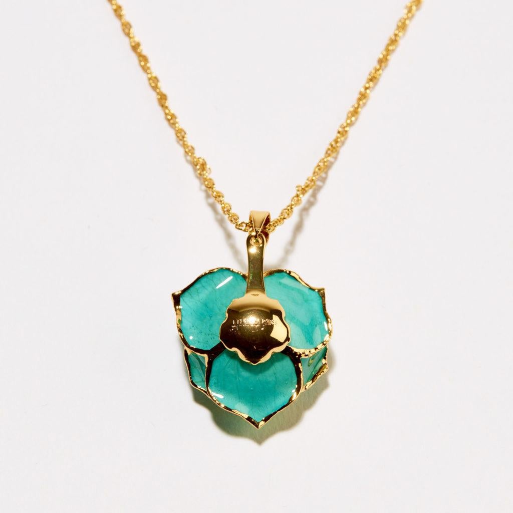 Put a little fun and whimsy into someone’s day with our Teal Rhapsody Eternal Necklace. Showcase your deep feeling with this beautiful teal rosebud, surrounded by gold trimmed accents. Your special someone will appreciate this gift for years to
