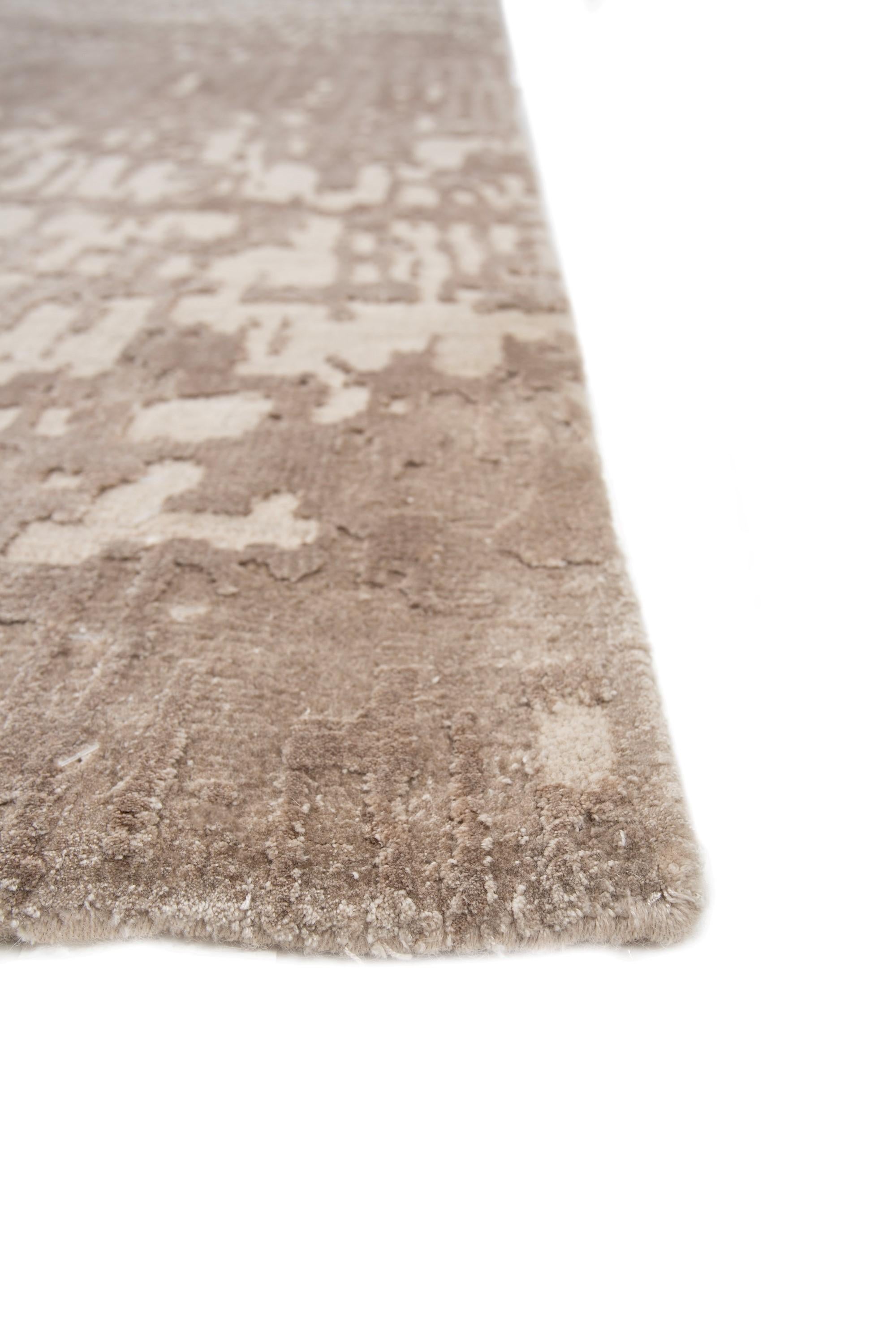 Elevate the mood with this tone-on-tone, hand-knotted rug crafted in rural India. Immerse your surroundings in instant uplift, as the antique white ground and white sand border seamlessly blend, offering a palette that radiates warmth and comfort.