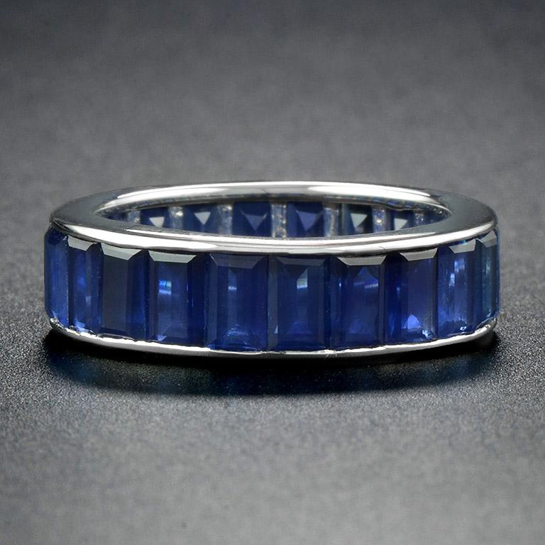 This classic Art Deco eternity ring was made in 18 Karat White Gold.  
The ring is composed of 22 gently baguette sapphires (size about 3 mm. x 5 mm.) with, the total weight of 7.75 Carat. 
The color matching is perfect.
Currently size 6 1/2.

We