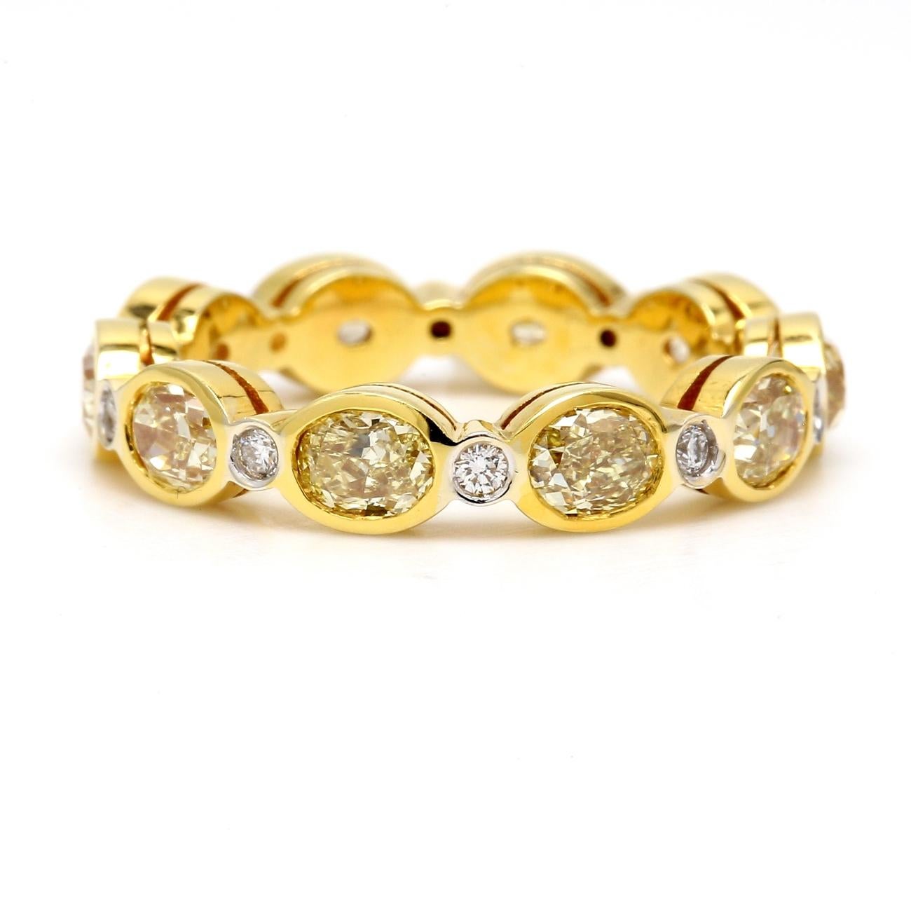 Eternity band in 18K YG with Rounds and Fancy Yellow Oval Diamonds. D3.29ct.t.w. In New Condition For Sale In Los Angeles, CA