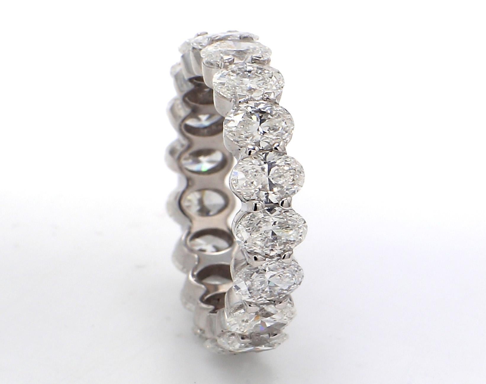Eternity band in platinum with basket claw prong set oval cut diamonds. D4.37ct.t.w.