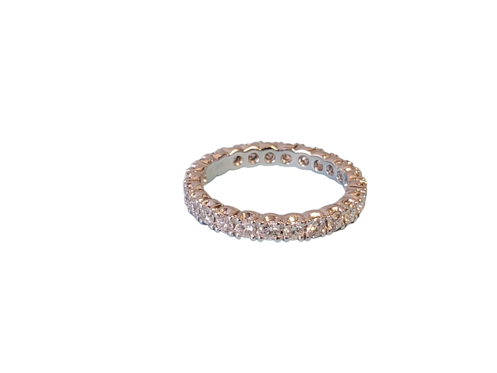 Listed is a beautiful platinum diamond eternity band with 1.18tcw white round brilliant diamonds all the way around. The stones are FG color and VS clarity that exhibit fire and scintillation. The ring is an unworn closeout piece, take advantage and