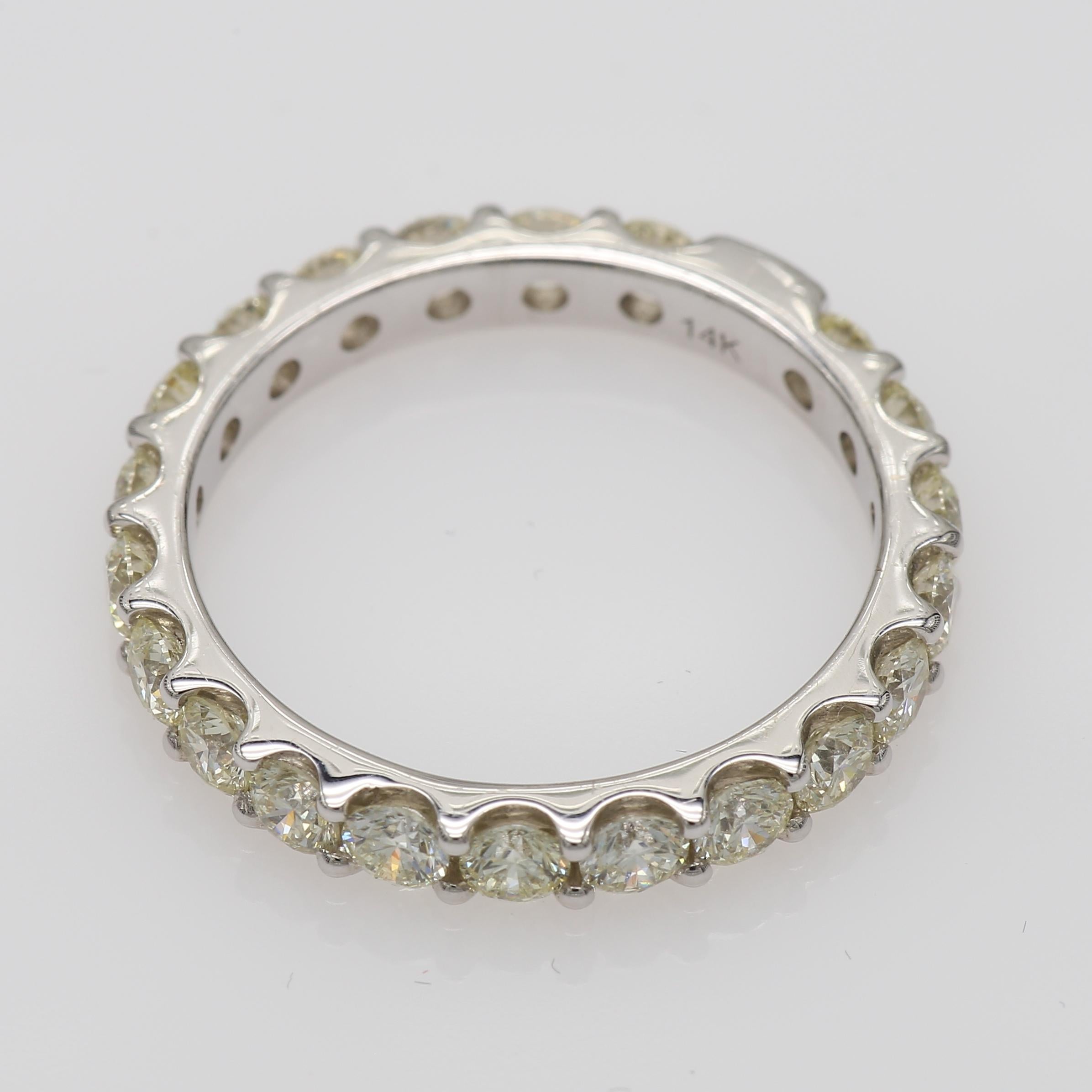 Delicate Eternity Band set with 21 Round Diamonds (Total Carat Weight 1.72 ) in 14 K White Gold. Upgrade your jewelry collection with this classic ring or gift it to your loved. Anyway this classci diamond eternity ring will bring you sparkles and