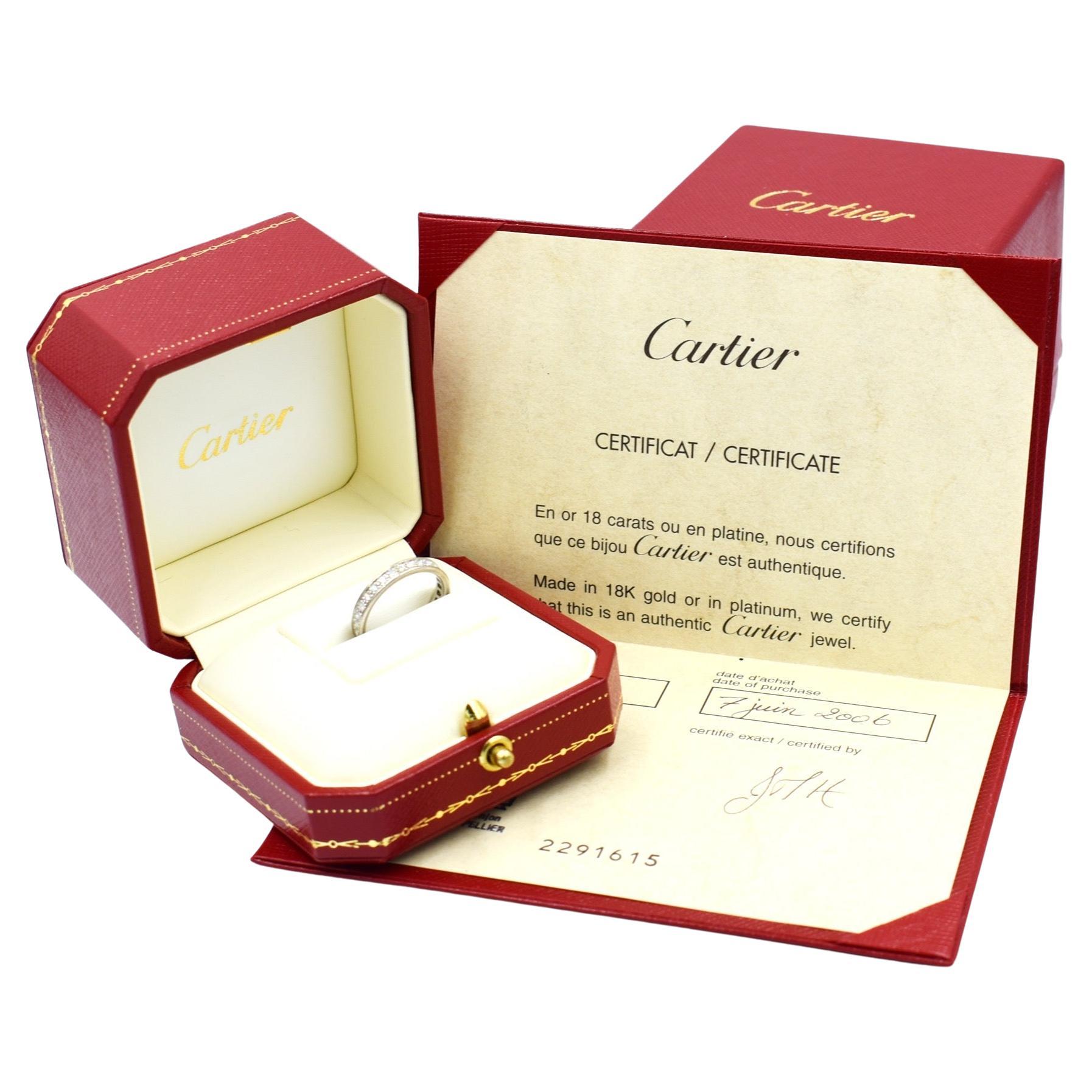 eternity ring from Cartier, in 18-carat white gold set with brilliant-cut diamonds all around the ring. This elegant and timeless ring is signed, numbered, and hallmarked by Cartier. It also comes with its box, case, and a certificate of