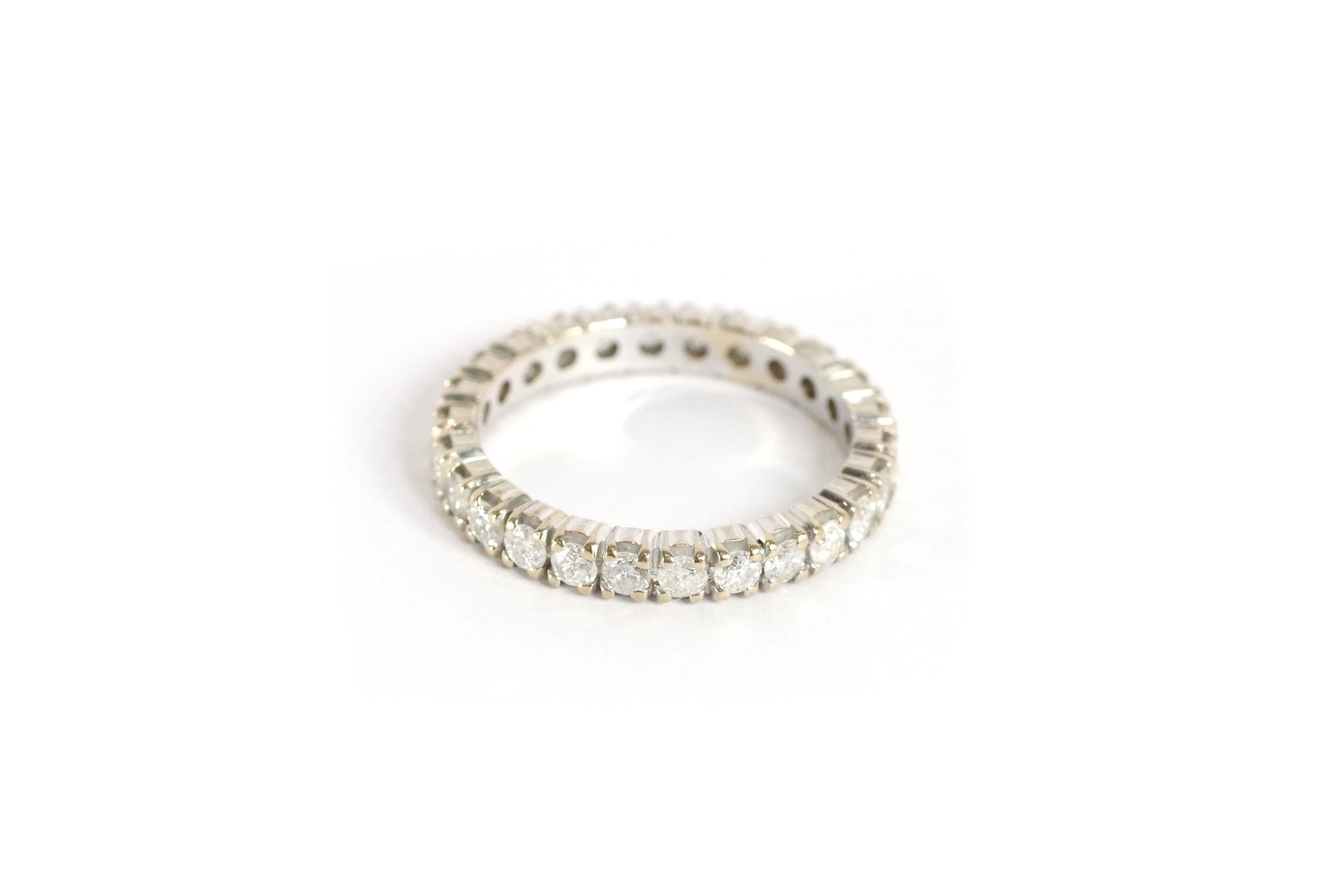 Eternity diamond ring in 18 karat white gold. Band set with 26 brilliant-cut diamonds. Vintage wedding band, eternity ring from the mid-20th century. 

Finger size: 52 EU or 5.75 US (no sizing possible).

Eagle head hallmark and illegible