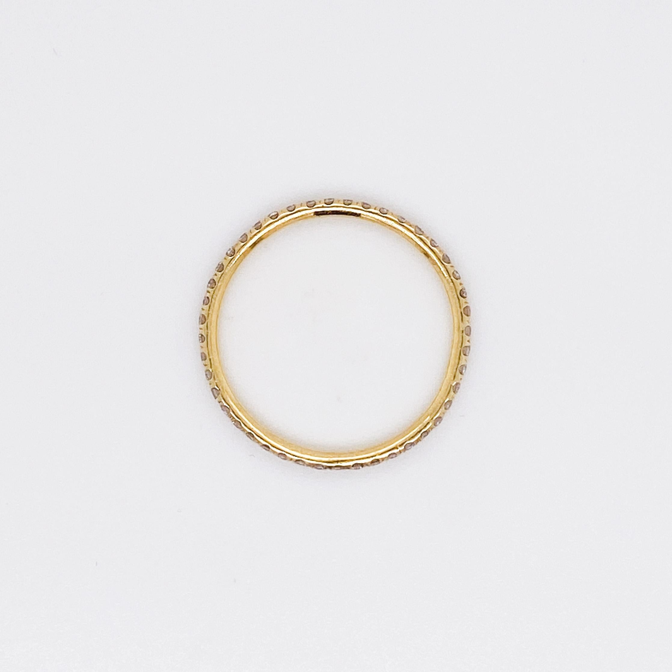 This slender eternity diamond ring is made in classic 18 karat yellow gold. The band is extremely comfortable to wear at only 1.7 mm wide and 1.5 mm in thickness. This is a perfect eternity band for wearing and forgetting you even have it on. If you