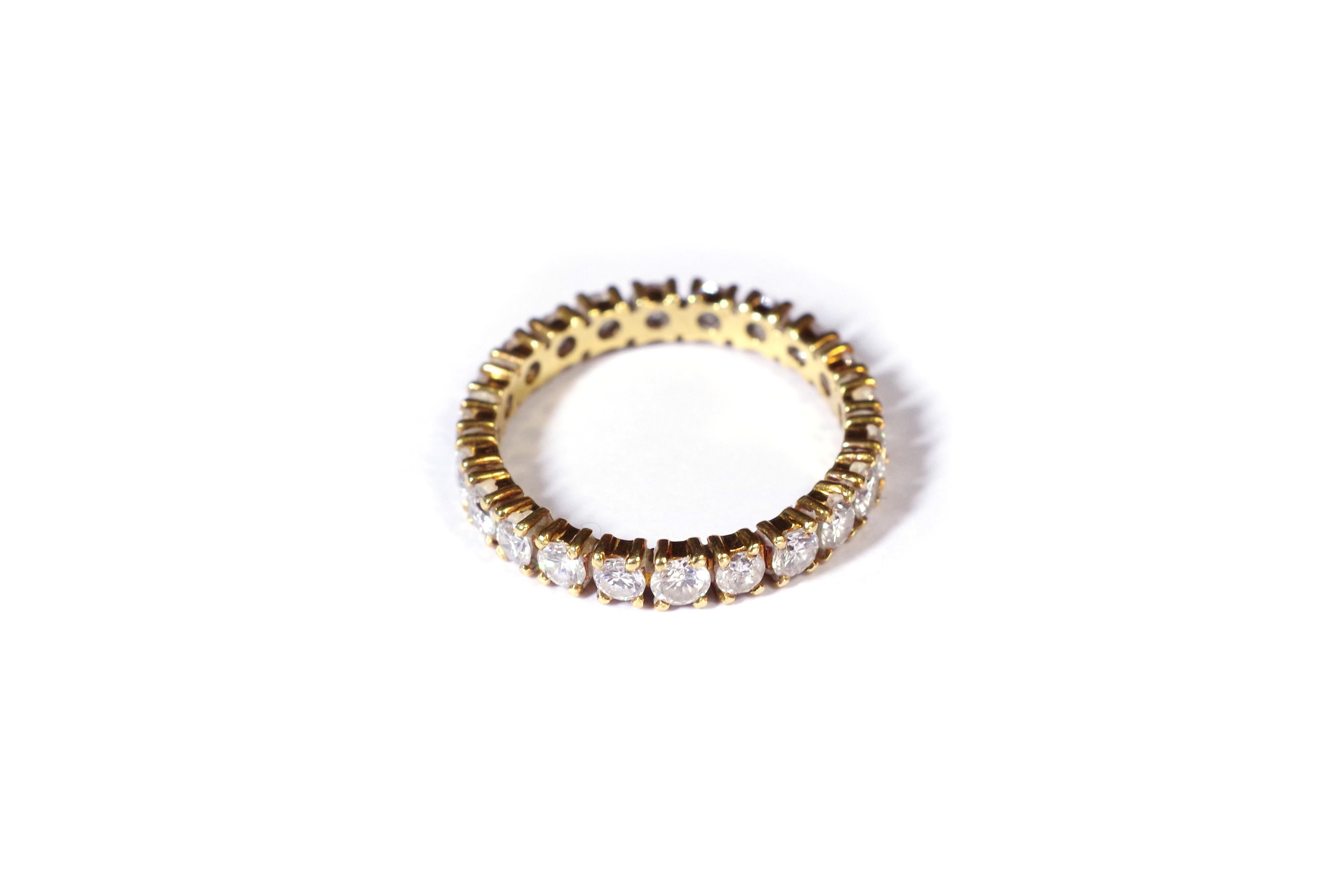 Eternity diamond wedding ring in yellow gold 18 karats. Ring set with twenty two brilliant cut diamonds weighing a total of approximately 1.10 carats. Eternity ring from the 1980's, France.

French mark eagle's head, partially erased

Finger size: