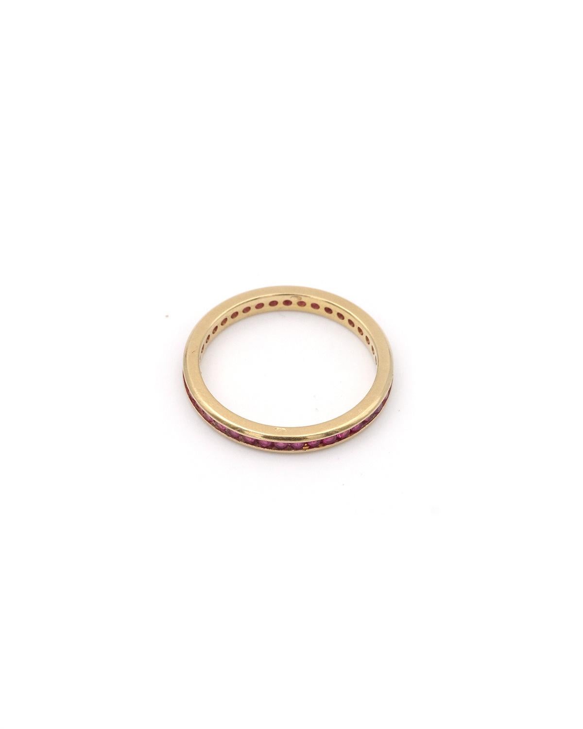Eternity natural ruby ring in 18 karat gold. This fine wedding band is set with a series of 39 natural rubies. The rubies are round and channel-set. A ruby wedding band, circa 1950, France.

Eagle head hallmark and partially engraved goldsmith's
