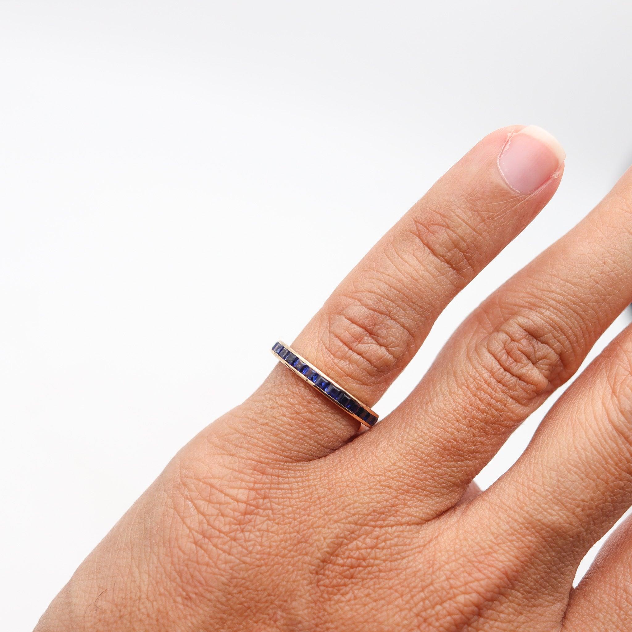 An eternity ring with sapphires.

This is a beautiful eternity band-ring, crafted with classic patterns in solid yellow gold of 14 karats with high polished finish. The delicate ring feature a concealed channel, which is embellished with a great