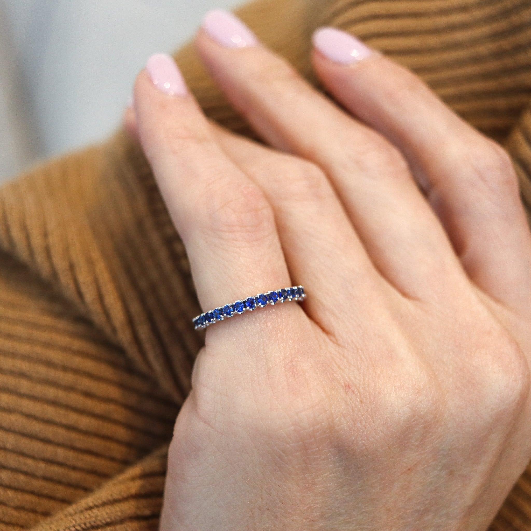 Eternity ring with natural blue sapphires.

This is a modern full eternity band, carefully crafted in solid white gold of 14 karats with high polished finish. The sides are plain with no design and is mounted in continuous prongs setting with thirty