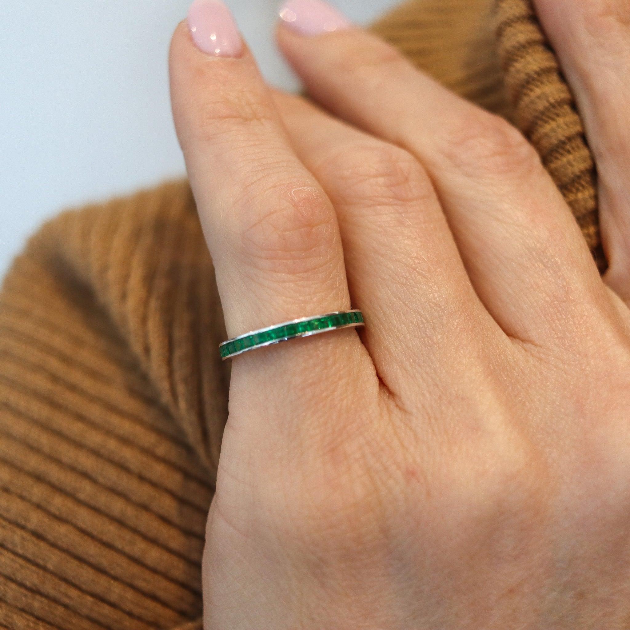 Eternity ring with natural green emeralds.

This is a modernist full eternity band, carefully crafted in solid white gold of 14 karats with high polished finish. The sides are plain with no design and is mounted in a channel setting with thirty-nine