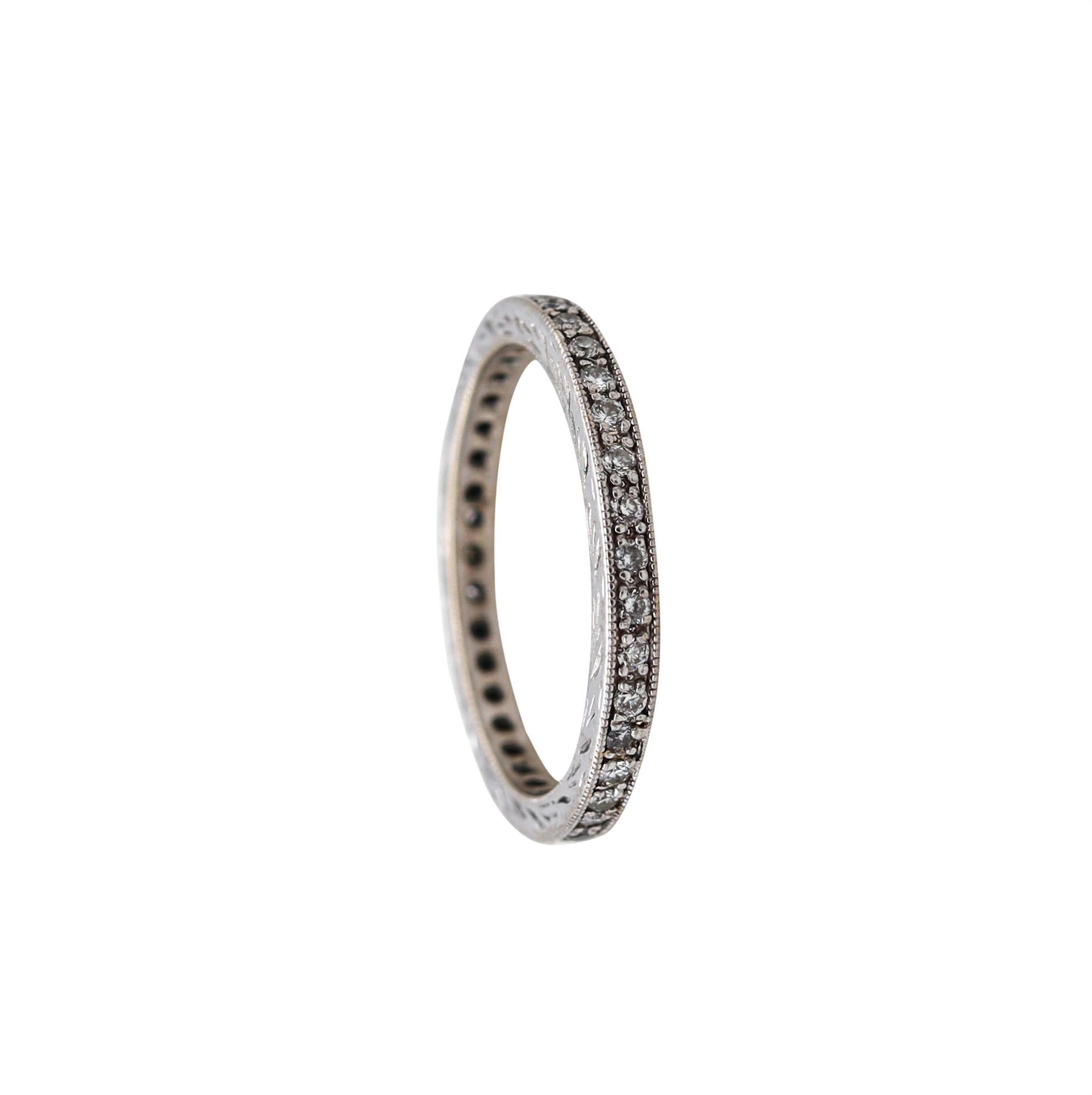 Eternity ring with Round Diamonds.

Beautiful vintage gem set ring band carefully crafted in solid white gold of 18 karats, with high polished finish and with the sides decorated with wreaths. It is mounted in a flat buttons prongs setting, with 38