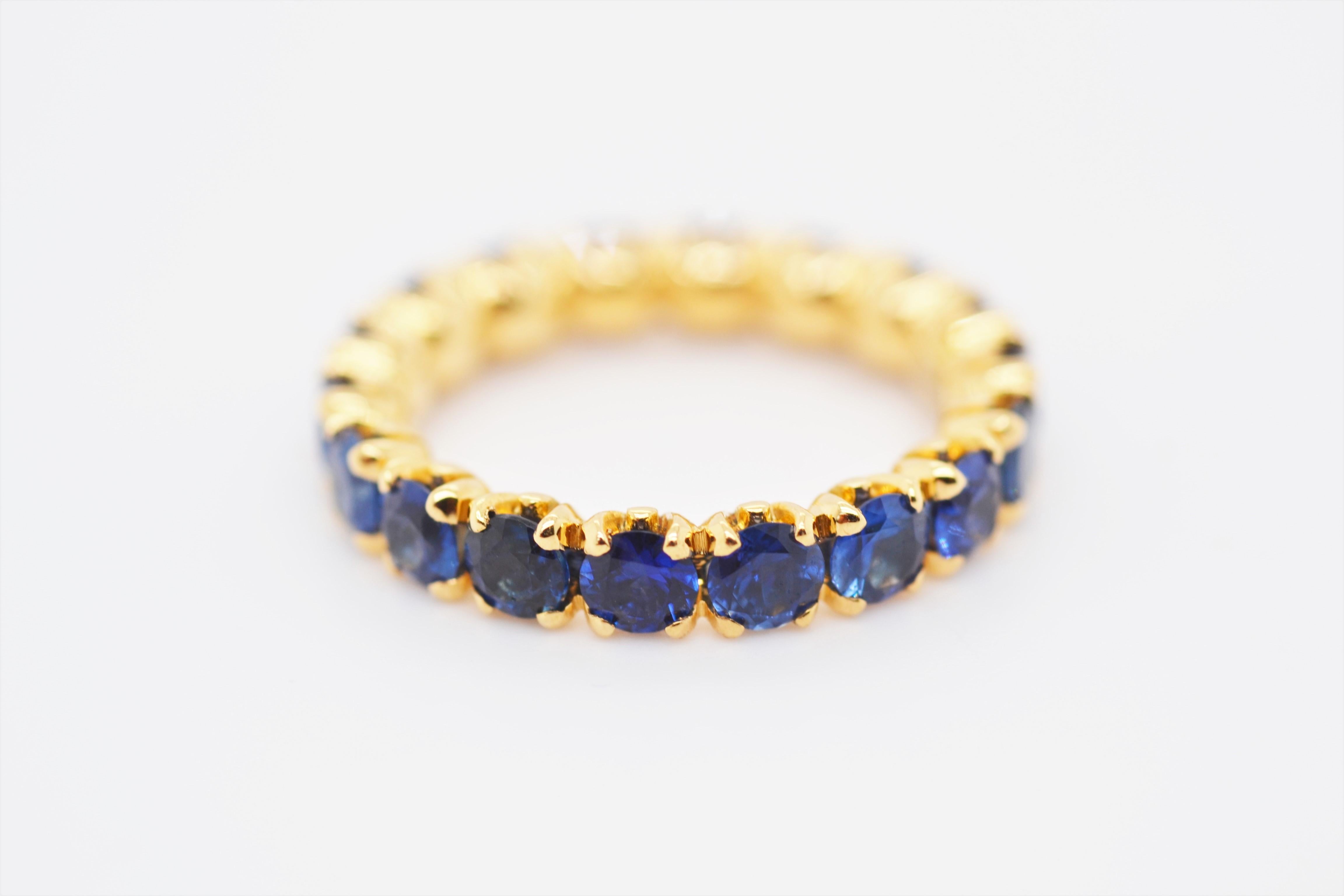 Contemporary Eternity Ring With Royal Blue Sapphires in 18 Karat Yellow Gold For Sale