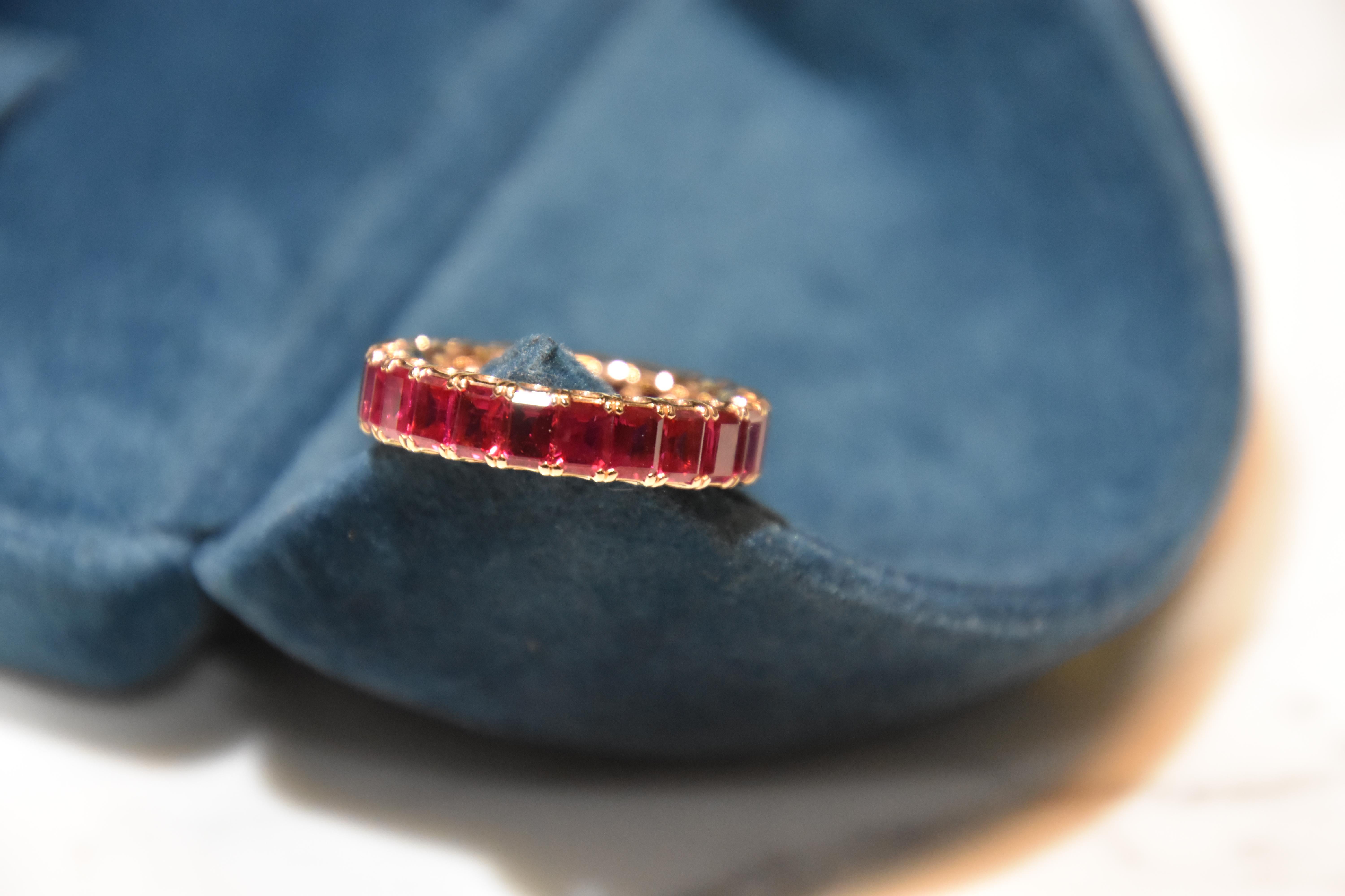 Each Ruby stone 0.25 carat. Total 23pcs/ 4.97 carat Ruby Eternity Ring set in 18K rose gold. You can order your own size. It takes around 4 weeks for delivery. 
Ring size- US 6,   Kahn also provide engraving, resizing, and cleaning service for the