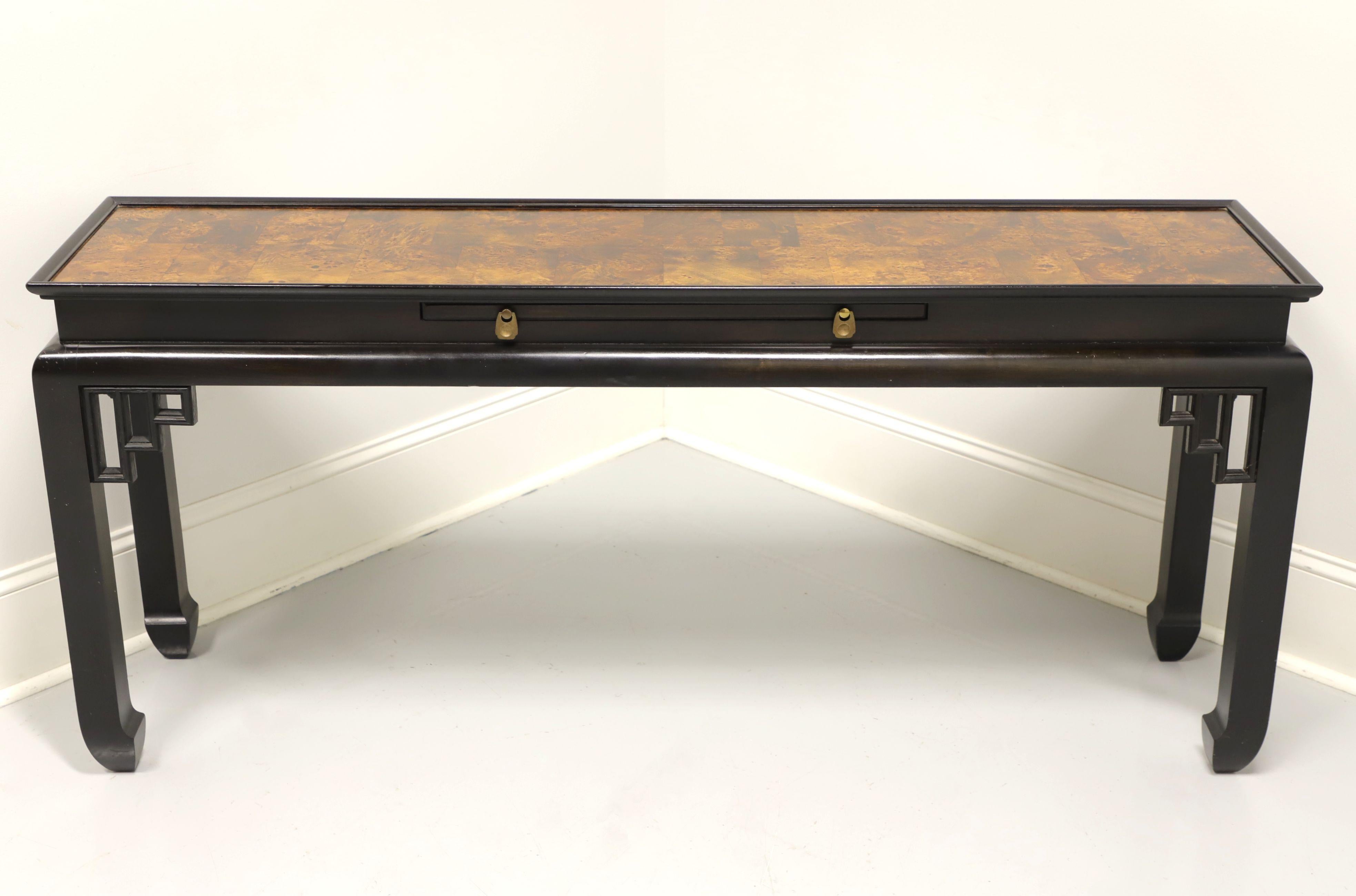 An Asian inspired console table by Ethan Allen. Solid hardwood with black lacquer, burl elm top, brass hardware and curved inward spade feet. Features decorative fretwork to corners and a center pull out tray. Made in the USA, in the late 20th