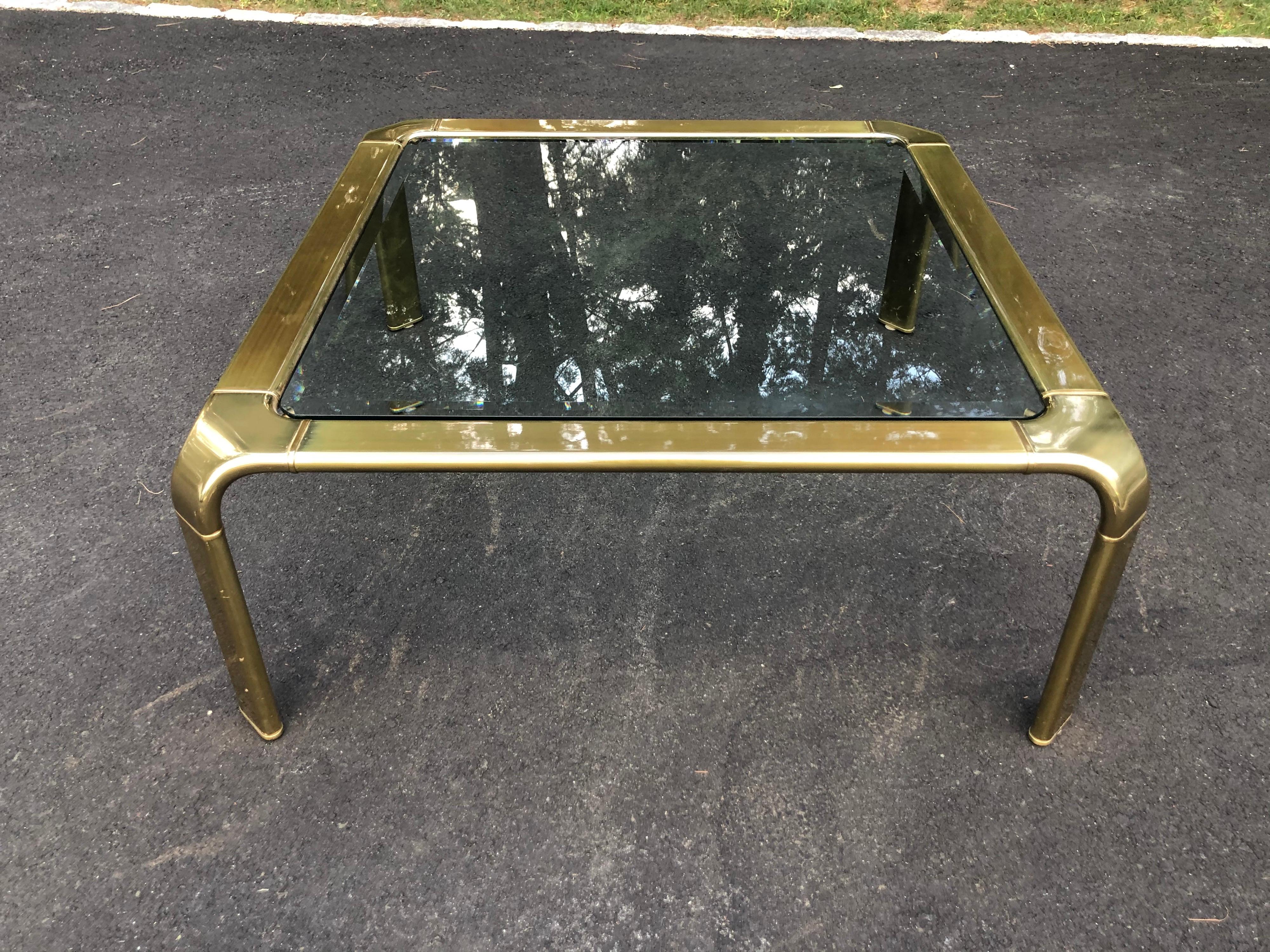 John Widdicomb style brass waterfall coffee table. In an antique brass finish. Sleek, elegant and timeless.