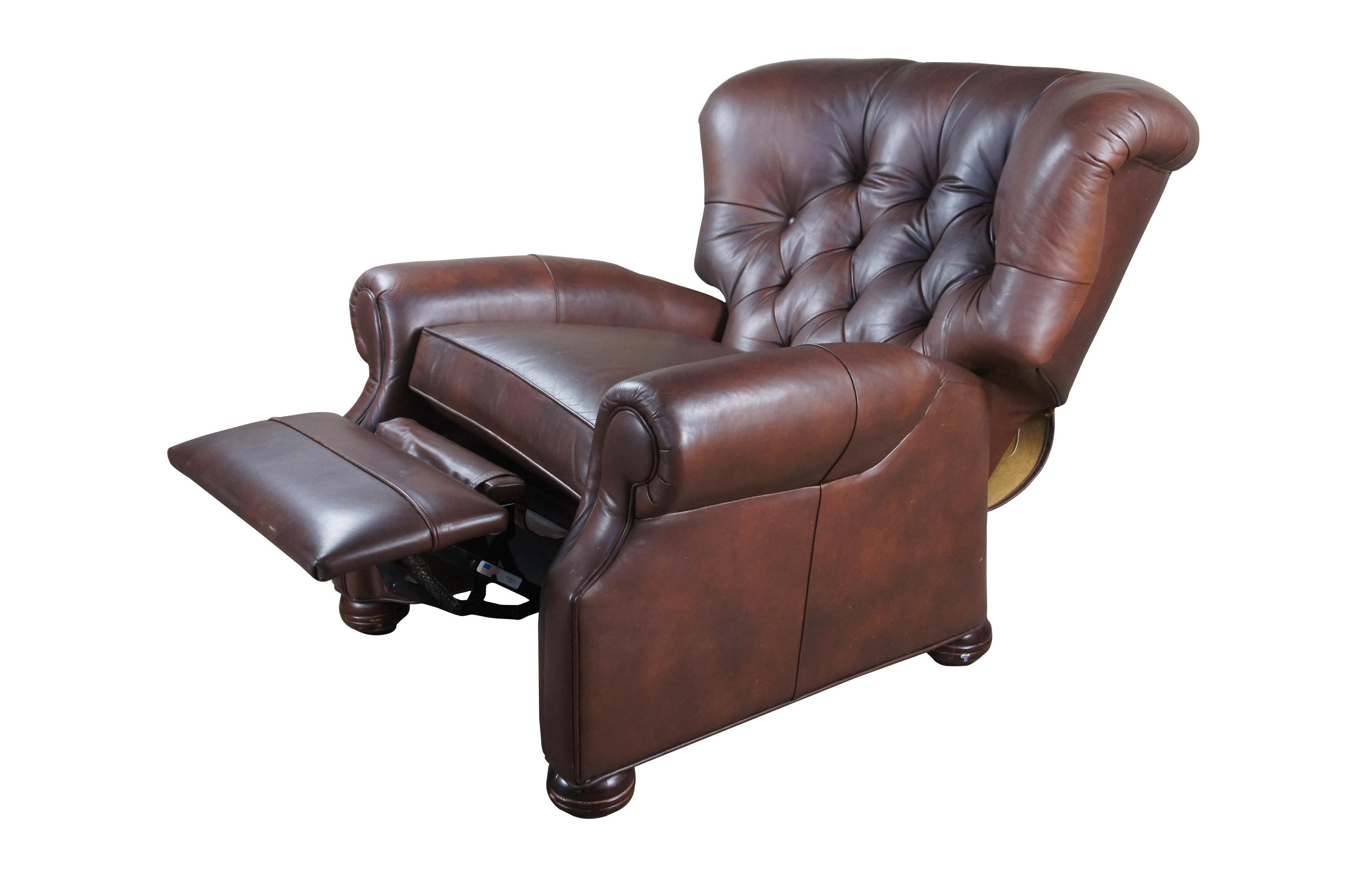 Vintage Ethan Allen brown leather Cromwell recliner featuring tufted back, rolled arms, wingback and bun feet.

Dimensions:
39