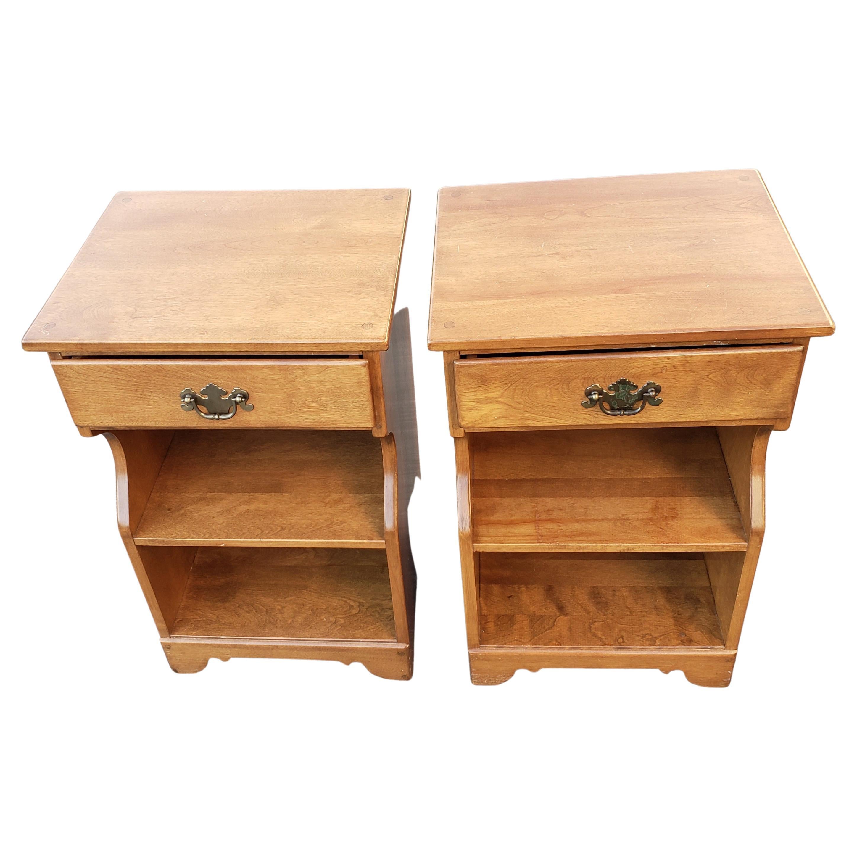 Beautiful pair of Ethan Allen 3-tier Maple with top drawer nightstands. This are one of the pieces designed by the founder of Ethan Allen, Theodore Baumritter. These jewels date from the 1960s. Very good vintage condition. Some wear, appropriate