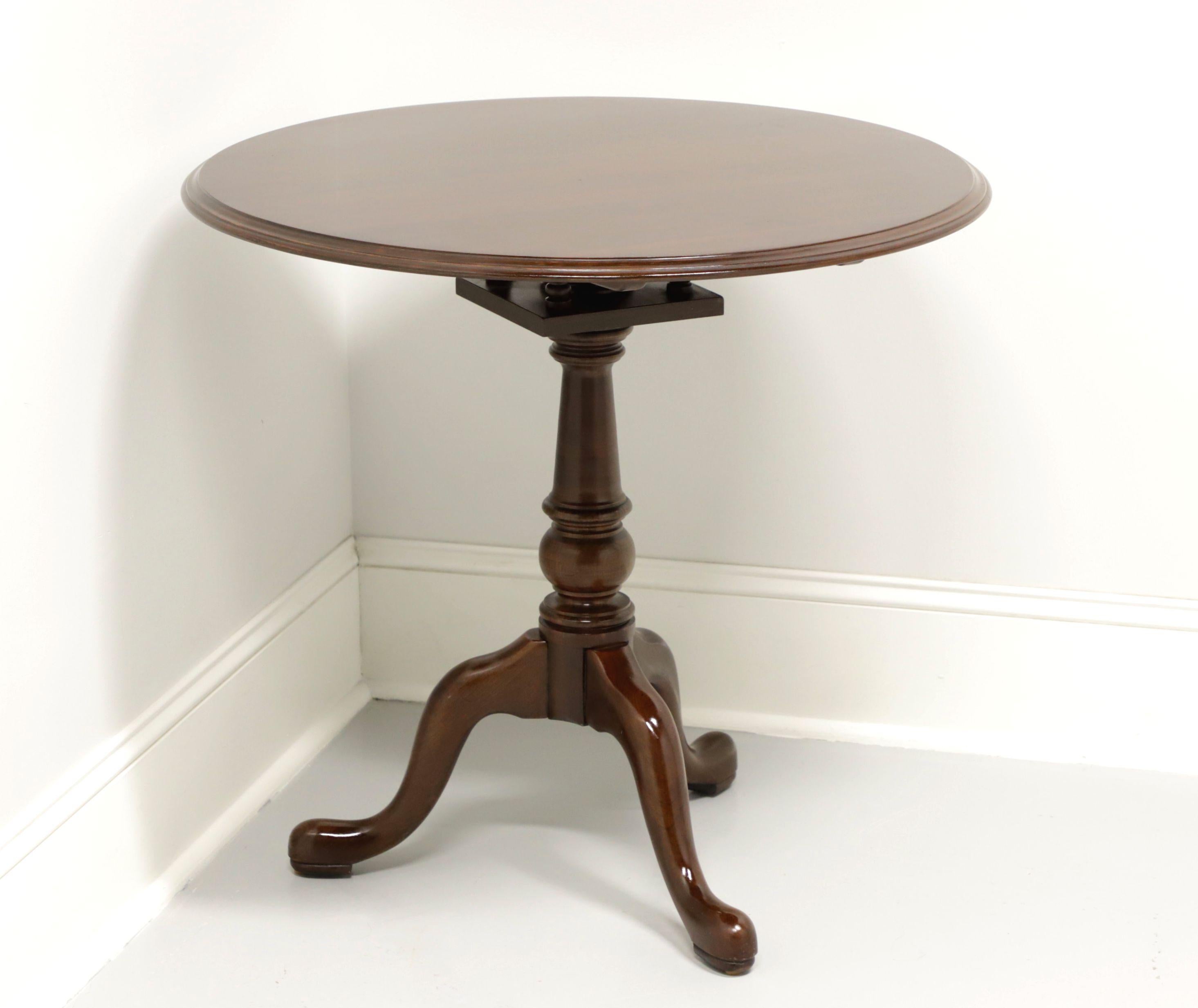 A Queen Anne style tilt-top pie crust table by Ethan Allen. Solid cherry with round top, ribbed edge, brass latch, turned pedestal with swivel, three legs and pad feet. Made in the USA, in the late 20th Century.

Measures:  Overall: Top Down: 30.25w