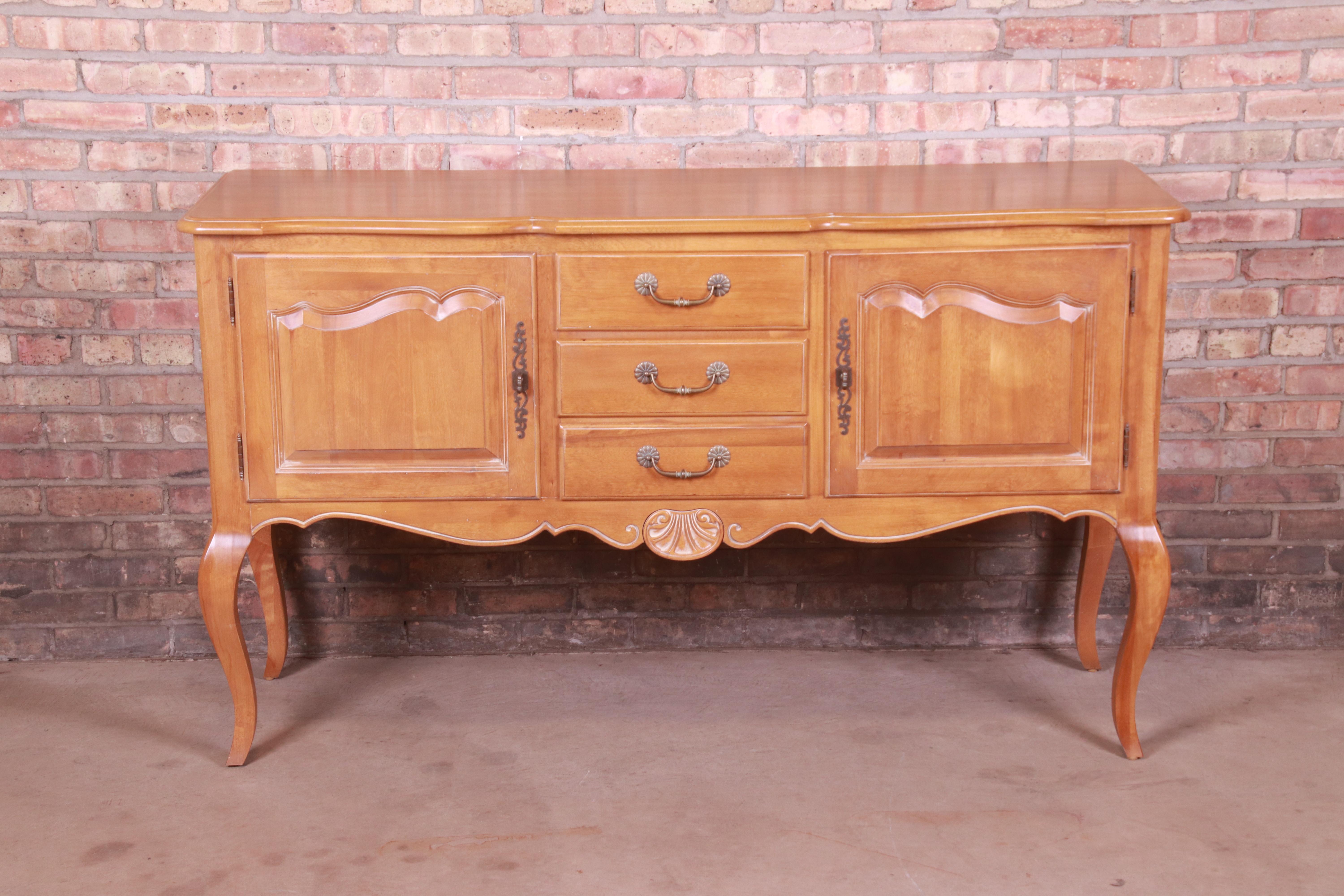 A gorgeous French Provincial style sideboard, credenza, or buffet server

By Ethan Allen

USA, Circa 1990s

Carved solid birch, with original brass hardware.

Measures: 62.5