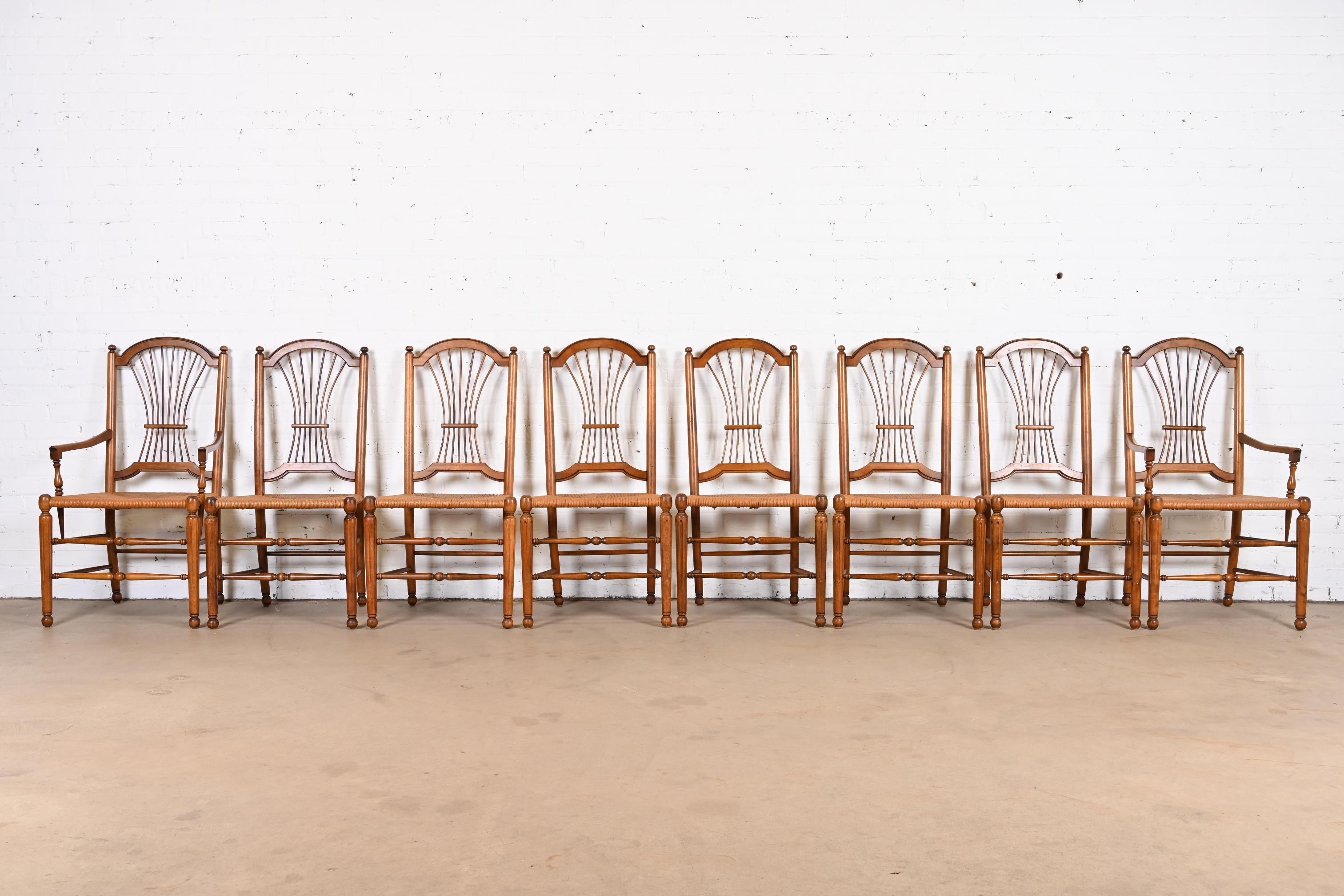 An outstanding set of eight French Provincial or Country French dining chairs

USA, Late 20th century

Carved solid birch frames, with rush seats.

Measures:
Side chairs - 20.5