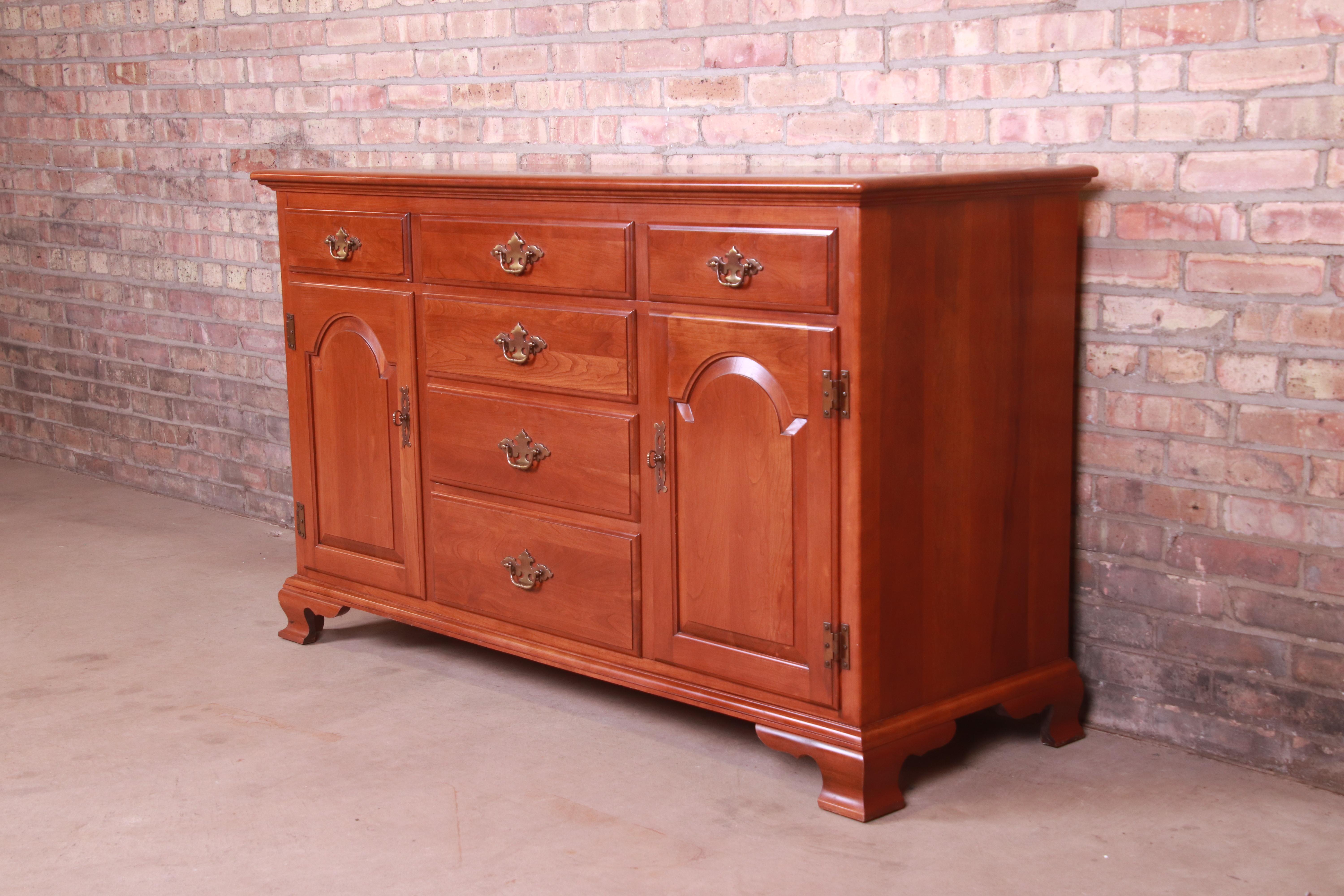 An American Colonial or Chippendale style sideboard, credenza, or bar cabinet

USA, Circa 1970s

Solid cherry wood, with original brass hardware.

Measures: 56.75