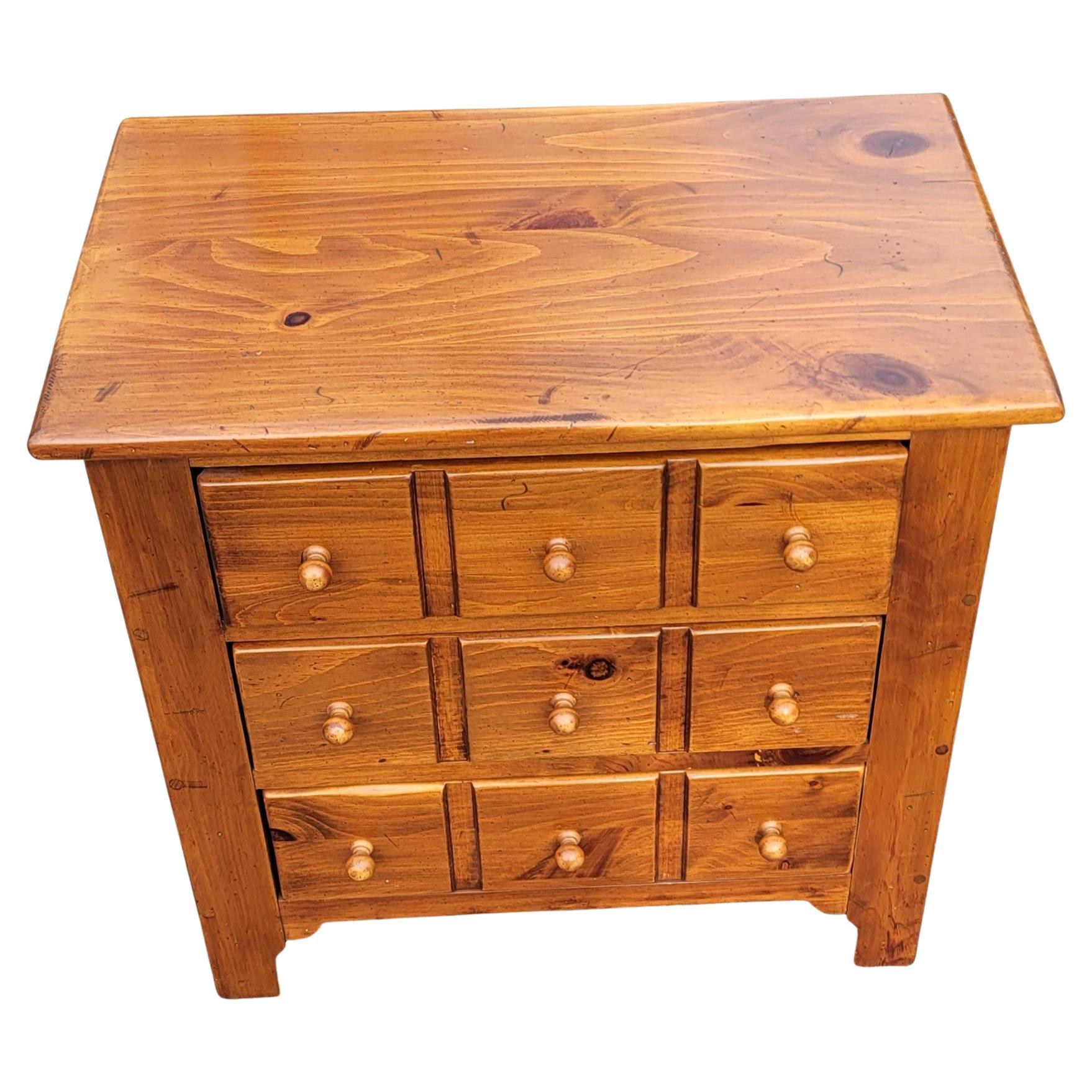 Ethan Allen Early American Style Bedside Chest of drawers / Nightstand. Features three drawers with dovetail joints showing like 9 drawers. Light weight pine wood.