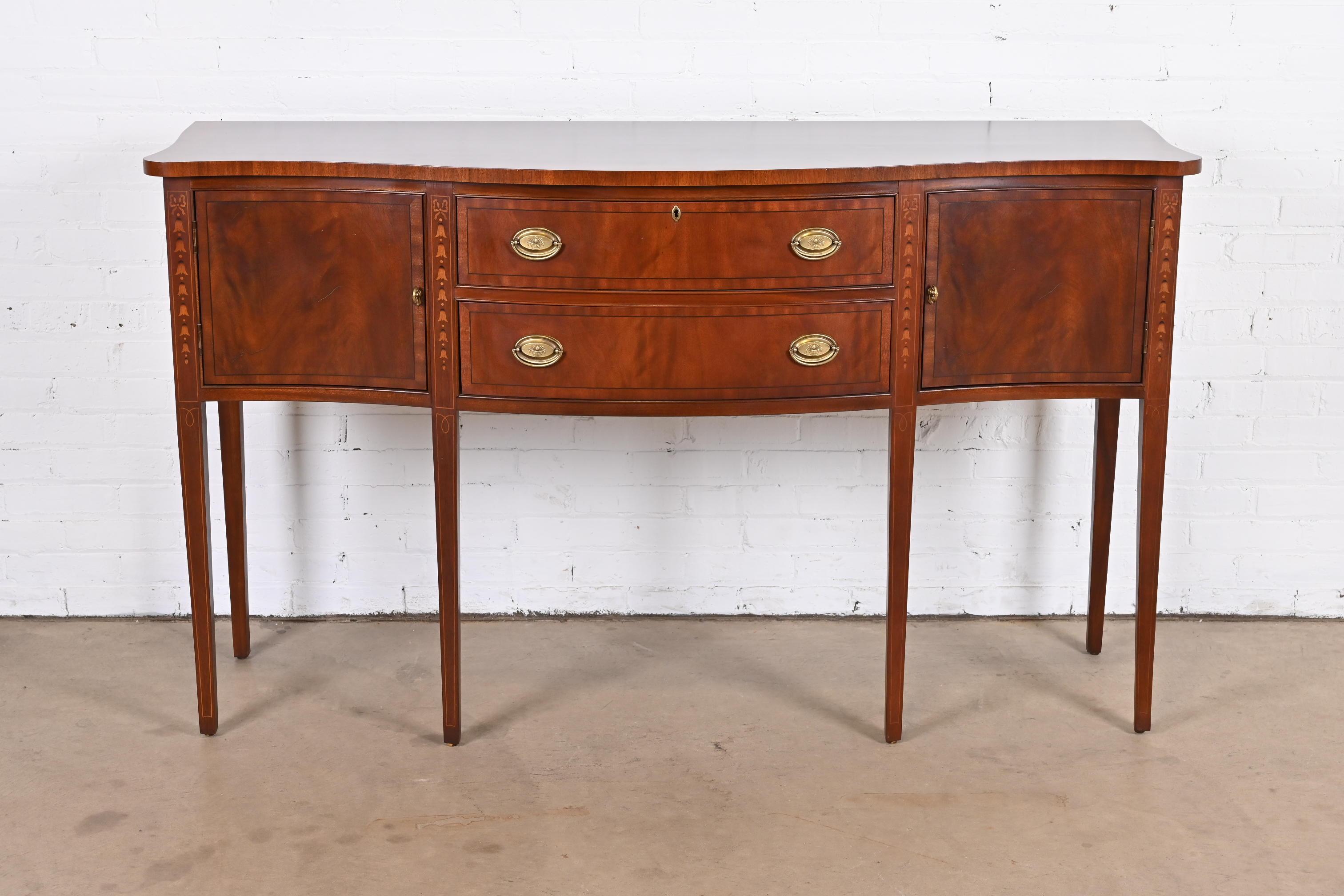 A gorgeous Federal or Hepplewhite style serpentine front sideboard, buffet, or credenza

By Ethan Allen

USA, late 20th century

Flame mahogany, with inlaid satinwood marquetry, and original brass hardware.

Measures: 65.5