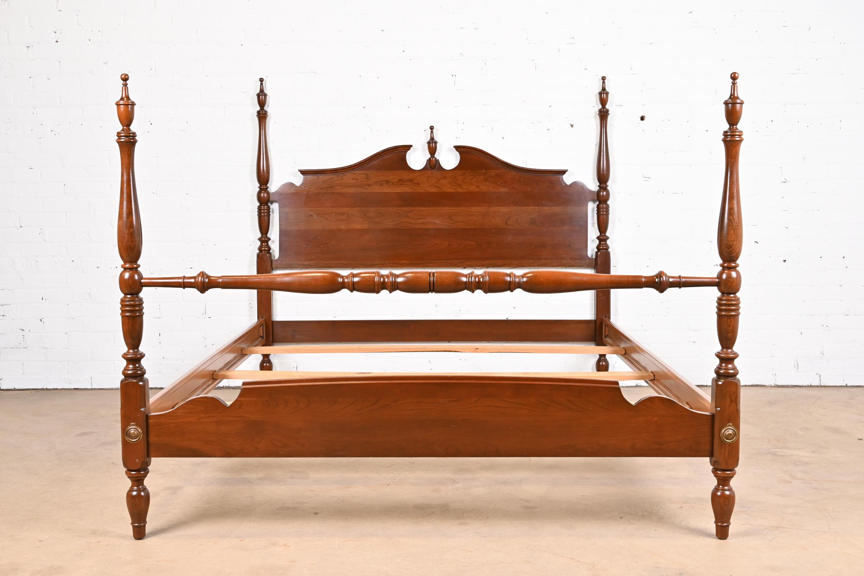 A gorgeous Federal or Georgian style four poster queen size bed

USA, Circa 1980s

Carved solid cherry wood, with brass accents.

Measures: 63.75