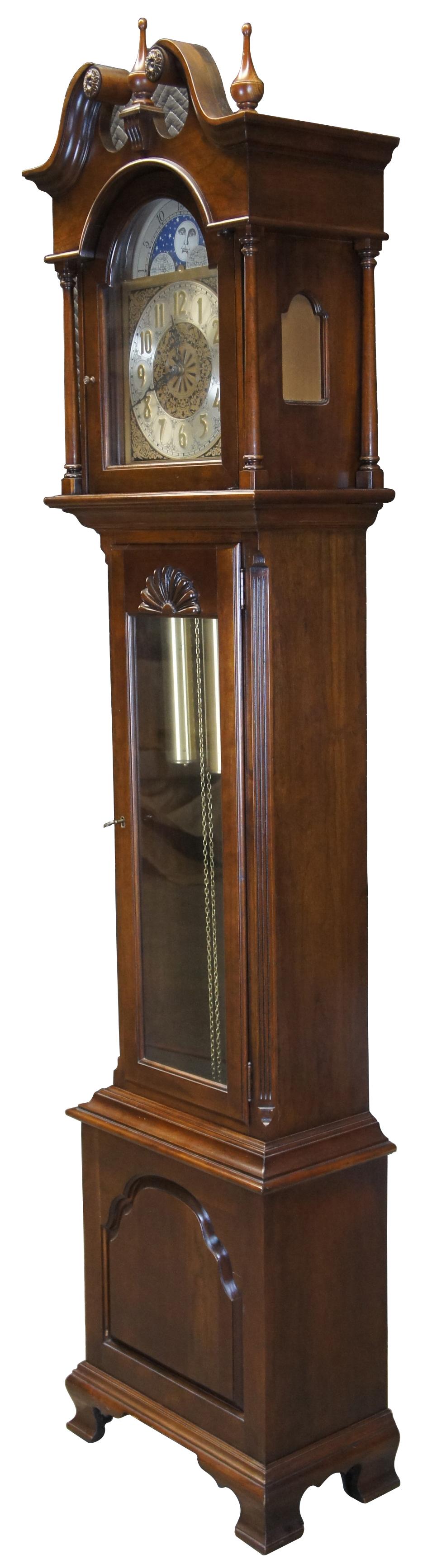 Ethan Allen Georgian Court grandfather clock, circa 1970s. Model number 08-3805; 225 finish. Features a cherry tall case with scrolled open pediment, 3 finials, turned posts and bracket feet. West German works with an ornately detailed face and moon