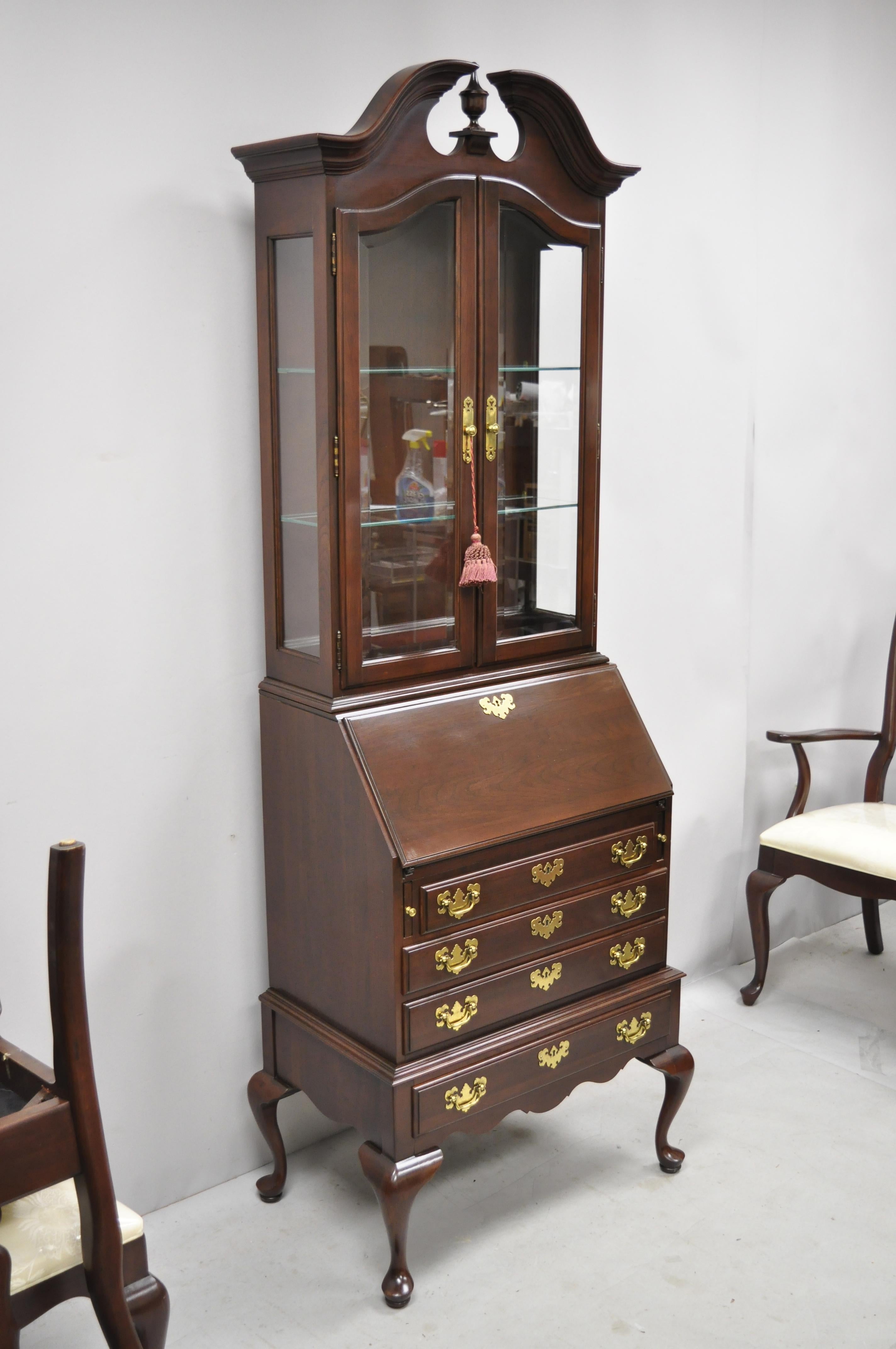 Ethan Allen Georgian court cherrywood Queen Anne fall front secretary desk. Item features a solid wood construction, beautiful wood grain, 2 part construction, lighted interior, 2 glass swing doors, original label, serial number [225 11-9203
