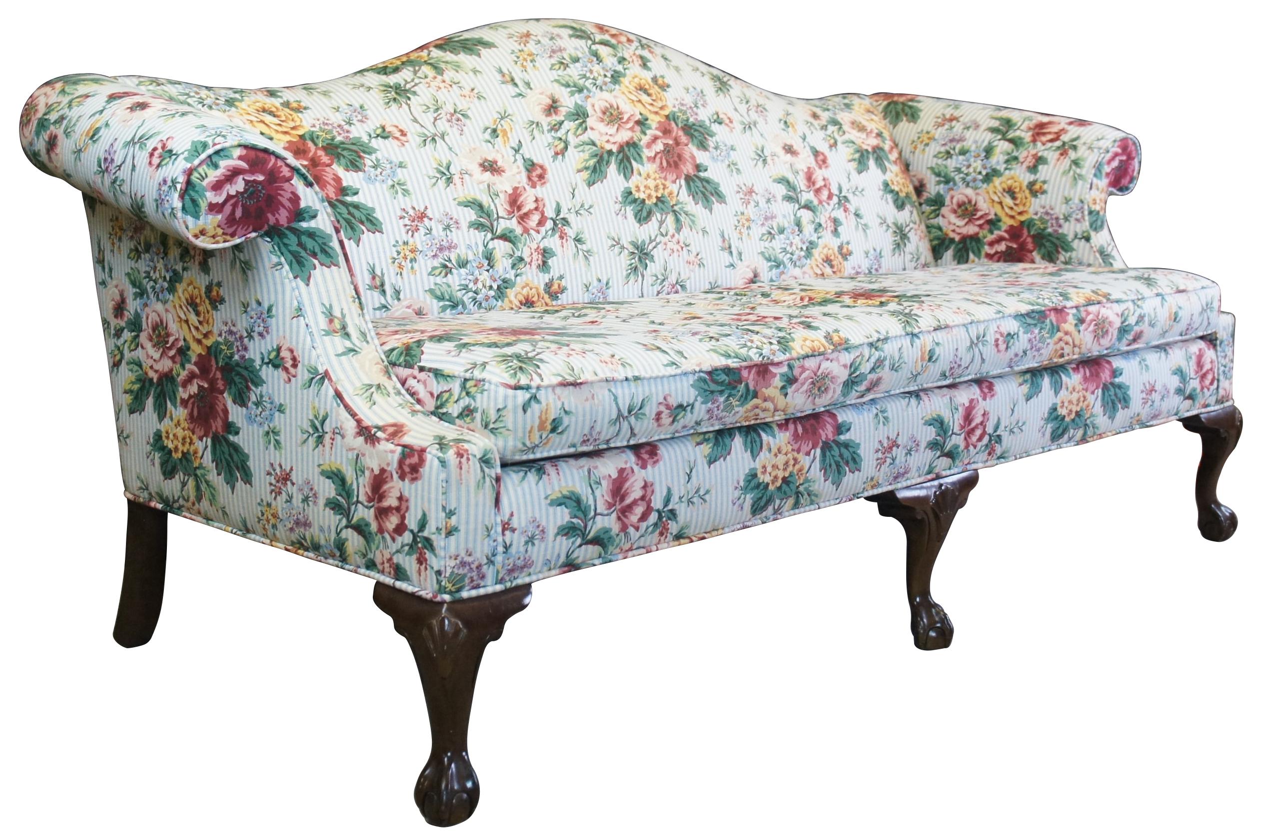 Ethan Allen Georgian Court Queen Anne or chippendale style camelback sofa Mp. 20-7179, circa 1970s. Made from cherry with cabriole legs featuring a shell carved knee and ball and claw feet. The sofa is upholstered in a blue and white fabric with