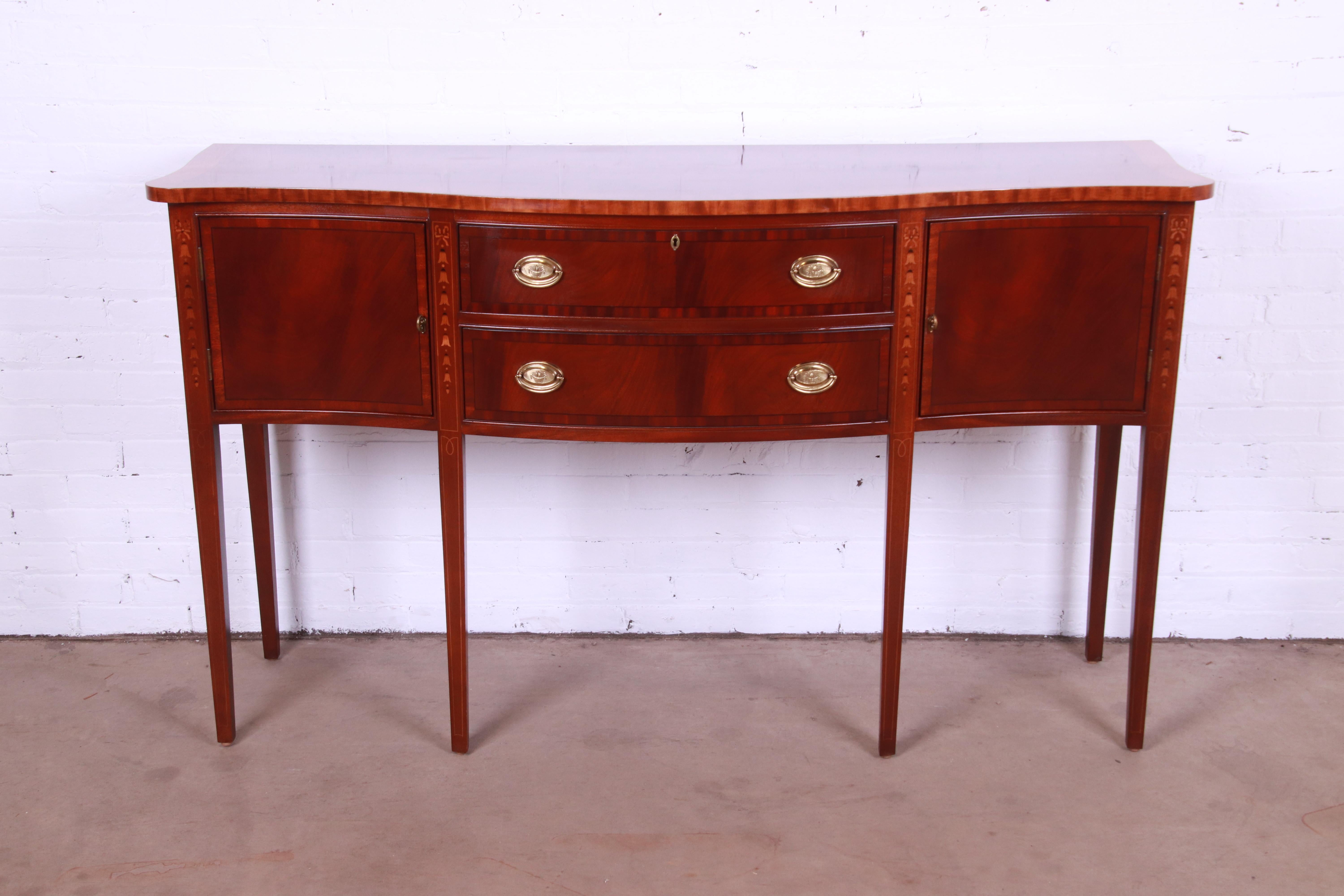 A gorgeous Hepplewhite style serpentine front sideboard, buffet, or credenza

By Ethan Allen

USA, Late 20th Century

Flame mahogany, with inlaid satinwood marquetry, and original brass hardware.

Measures: 65.5