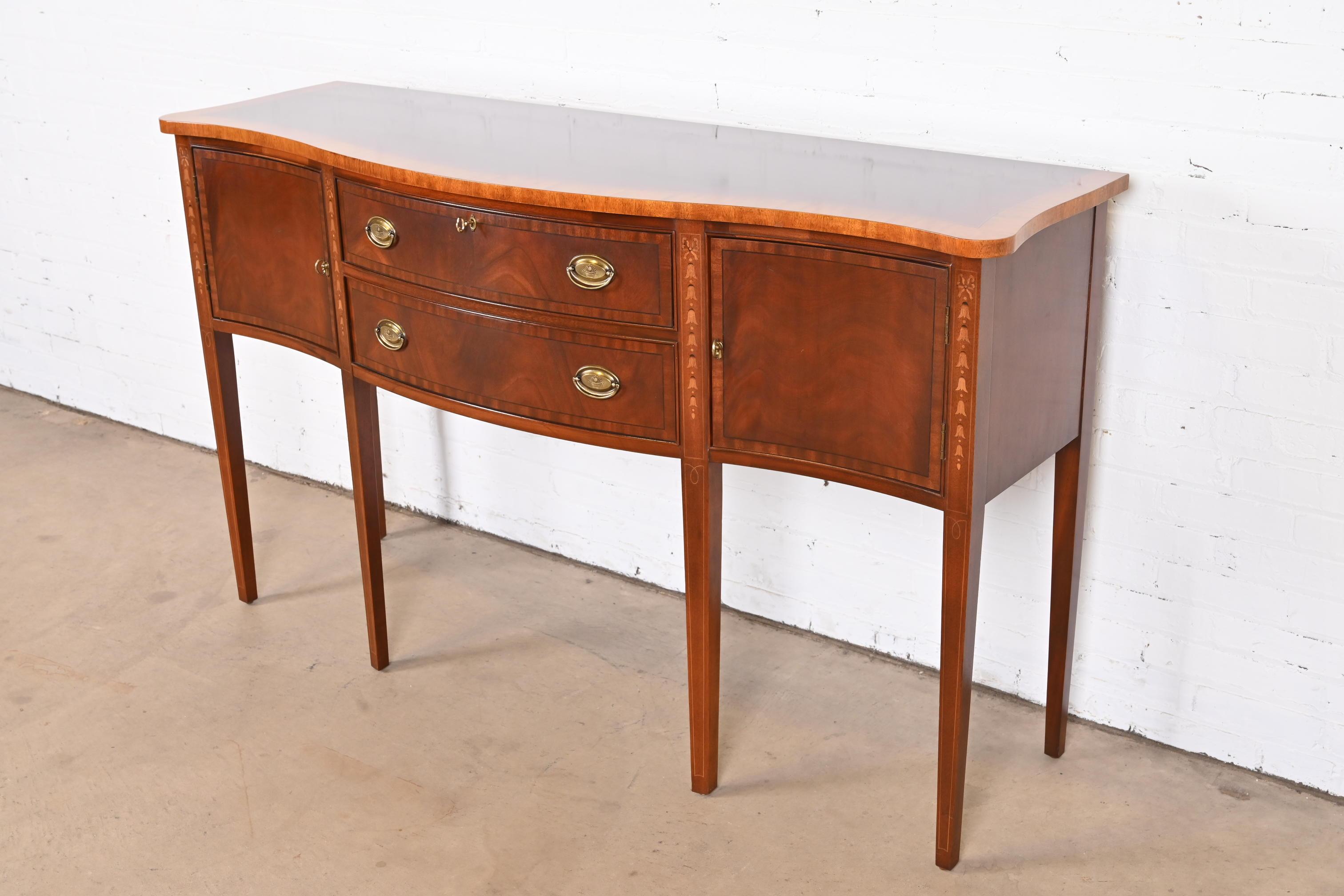 A gorgeous Hepplewhite or Federal style serpentine front sideboard, buffet, or credenza

By Ethan Allen

USA, Late 20th Century

Flame mahogany, with inlaid satinwood marquetry and banding, and original brass hardware.

Measures: 65.5