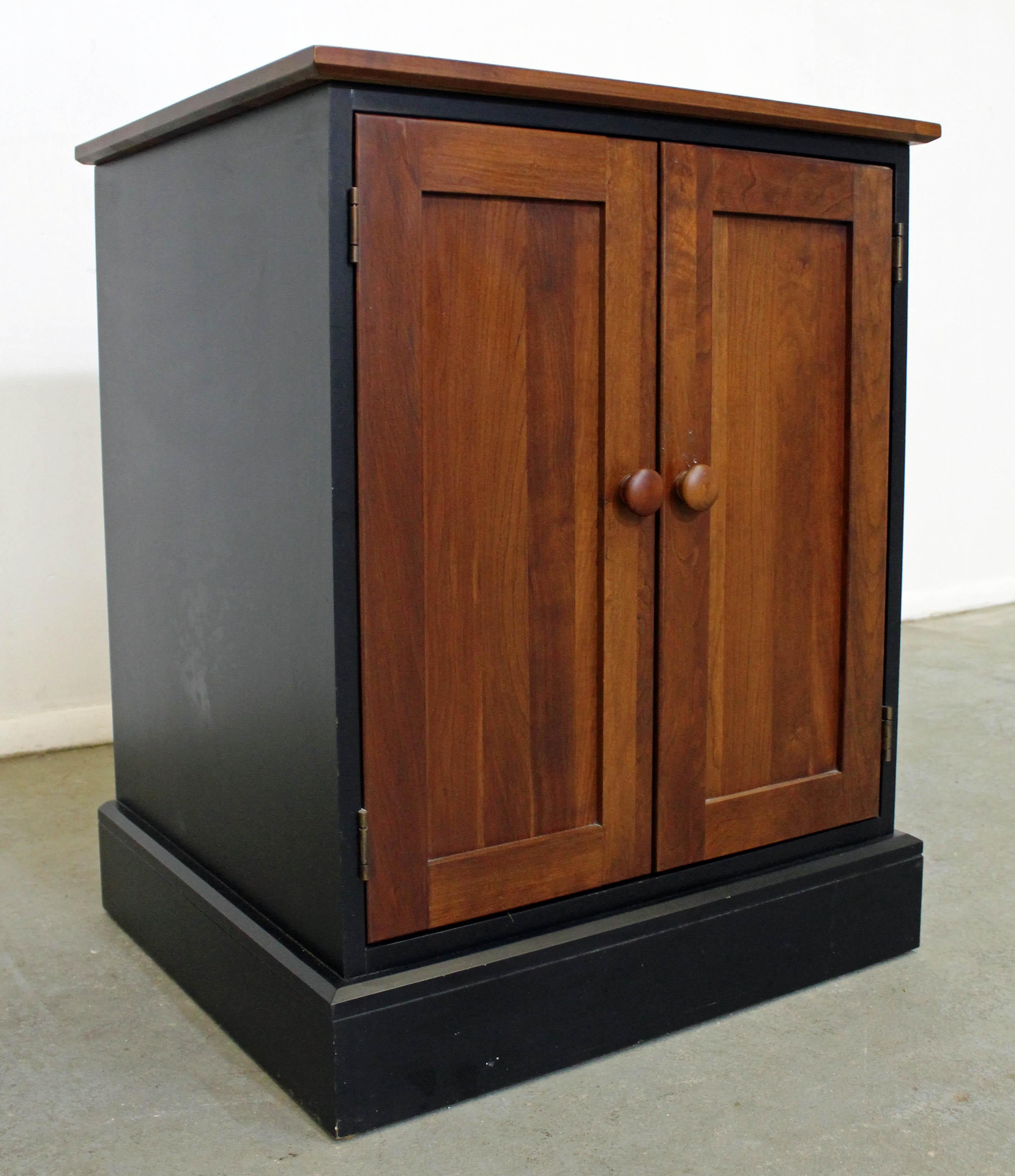 Offered is an cherry Ethan Allen 'American Impressions' nightstand/cabinet with black accents, in 620 autumn cherry with satin black finish. Features two doors and three adjustable shelves inside. This line drew inspiration from the Arts & Craft and
