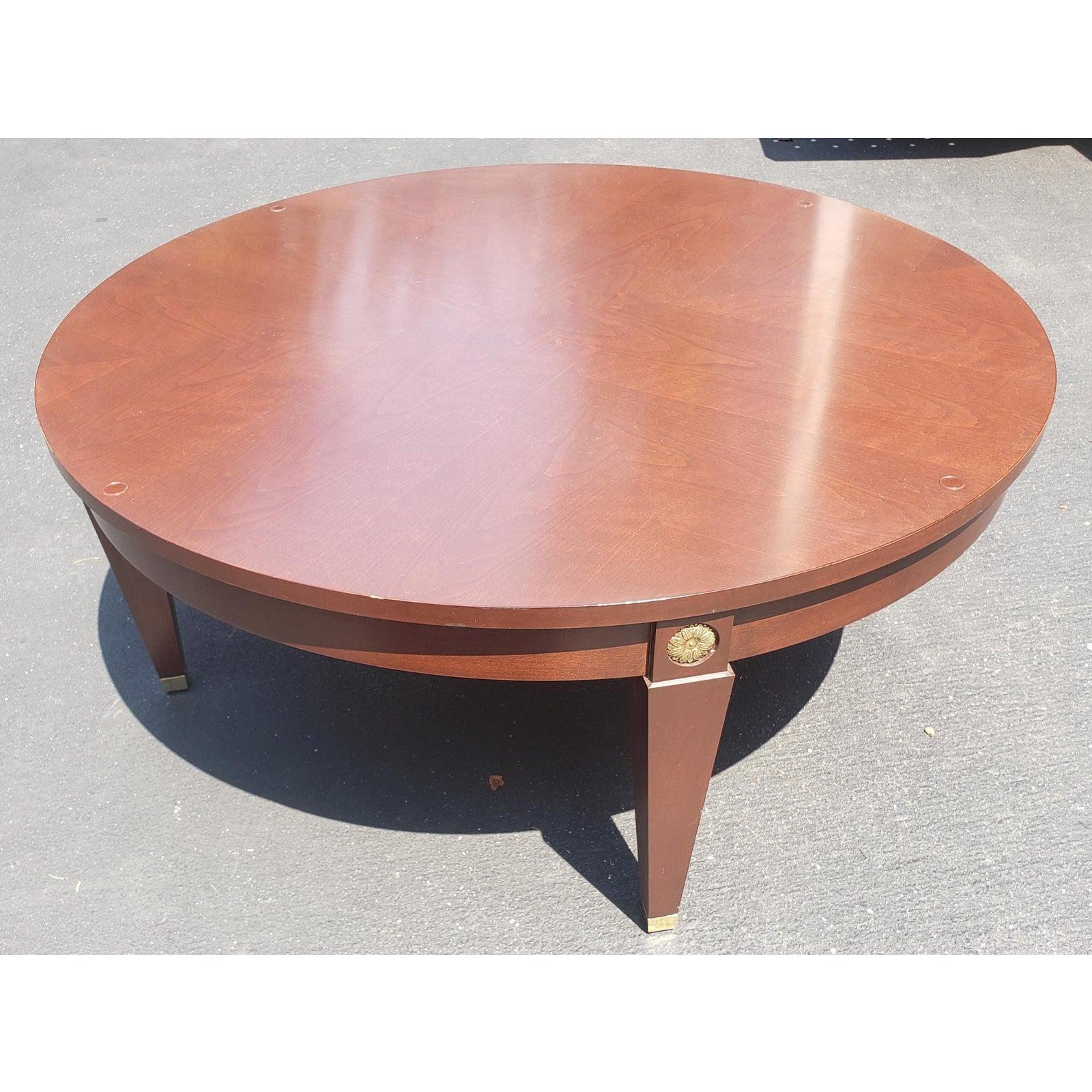 Round mahogany table with custom fitted glass top by Ethan Allen. Brass capped leg with brass medallion on each leg. Excellent condition.
Measures 40