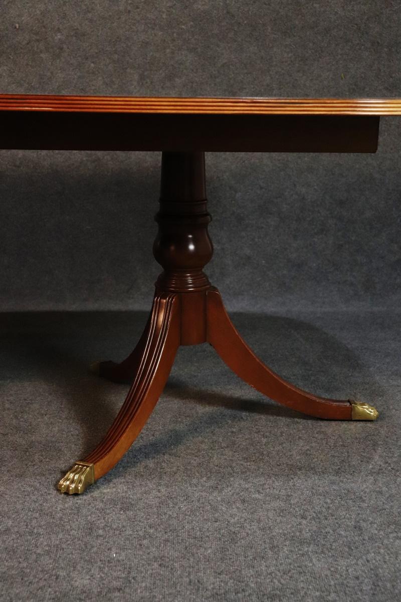 Satinwood and burled walnut banded mahogany Ethan Allen Regency style dining room table with 2 16