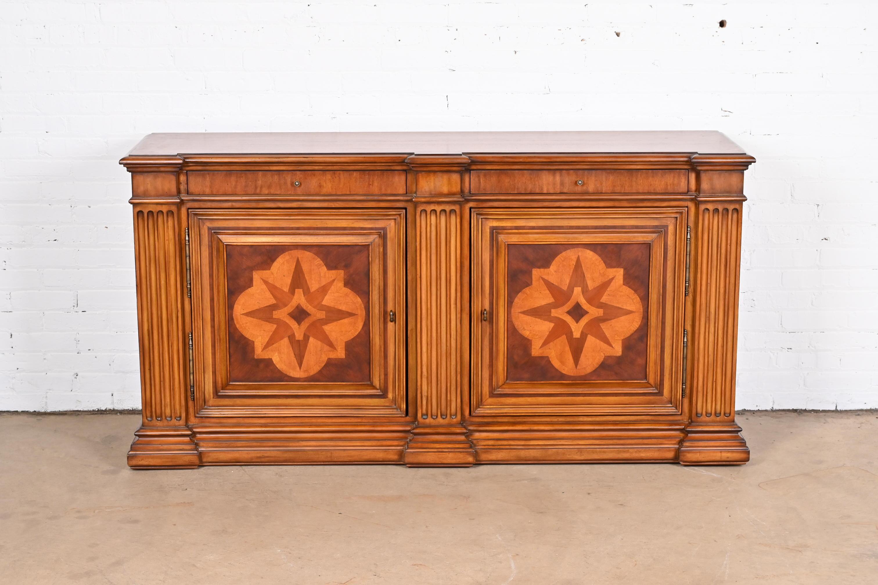 A gorgeous Neoclassical style sideboard, credenza, or bar cabinet

By Ethan Allen

Circa 1990s

Carved walnut, with inlaid marquetry and original brass hardware.

Measures: 71