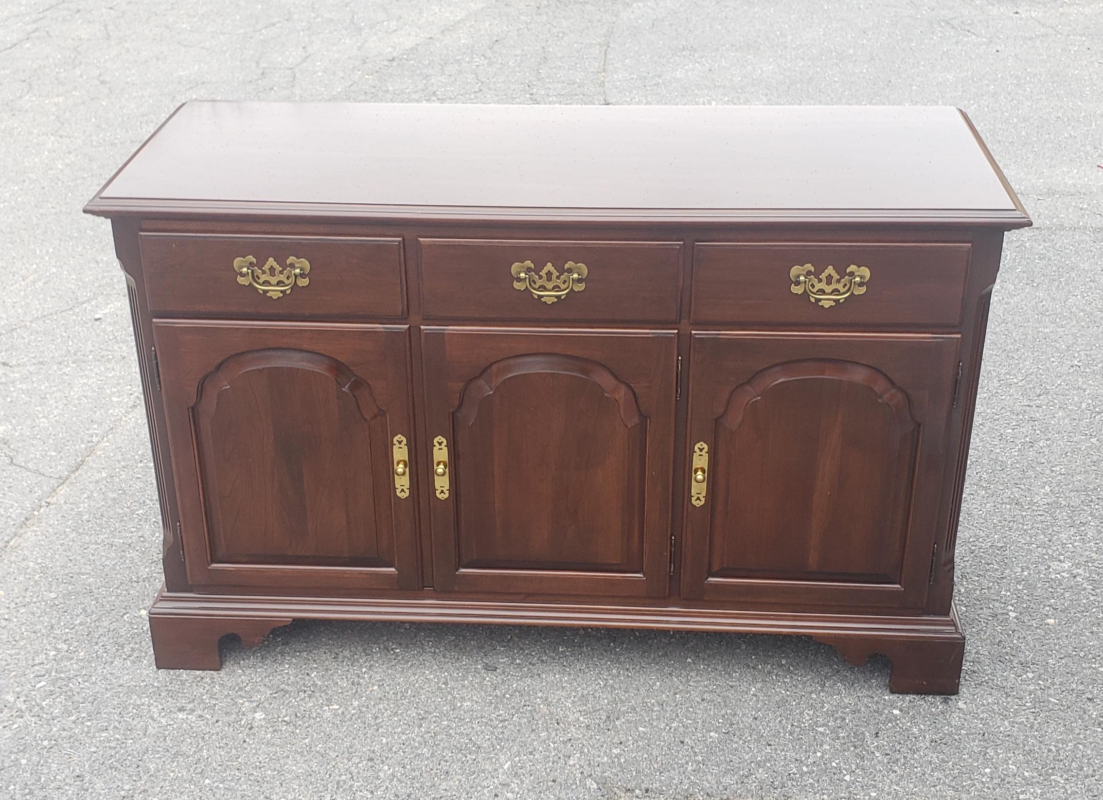 A chippendale style panelized doors buffet / credenza. Made out of dark solid cherry. Features 3 top dovetail constructed drawers, with one drawer originally set up and lined with soft fabric for to better protect you flatware and silverware.
The