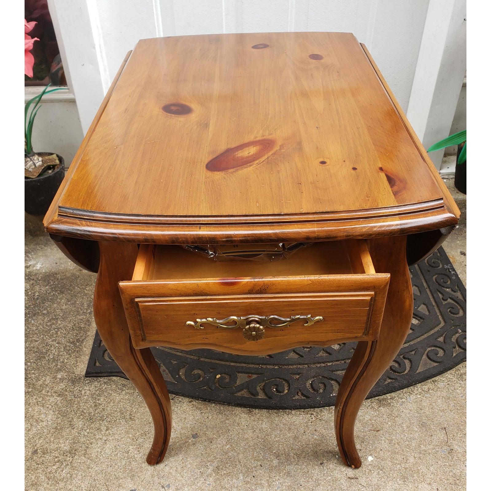 Ethan Allen Georgian court solid pinr drop leaf side table. Finish. Very good vintage furniture condition, Normal age wear, such a light scuffs on surface from normal daily use. Dimensions are 23 inches high, 28 inches deep, 36 inches wide, 19.5