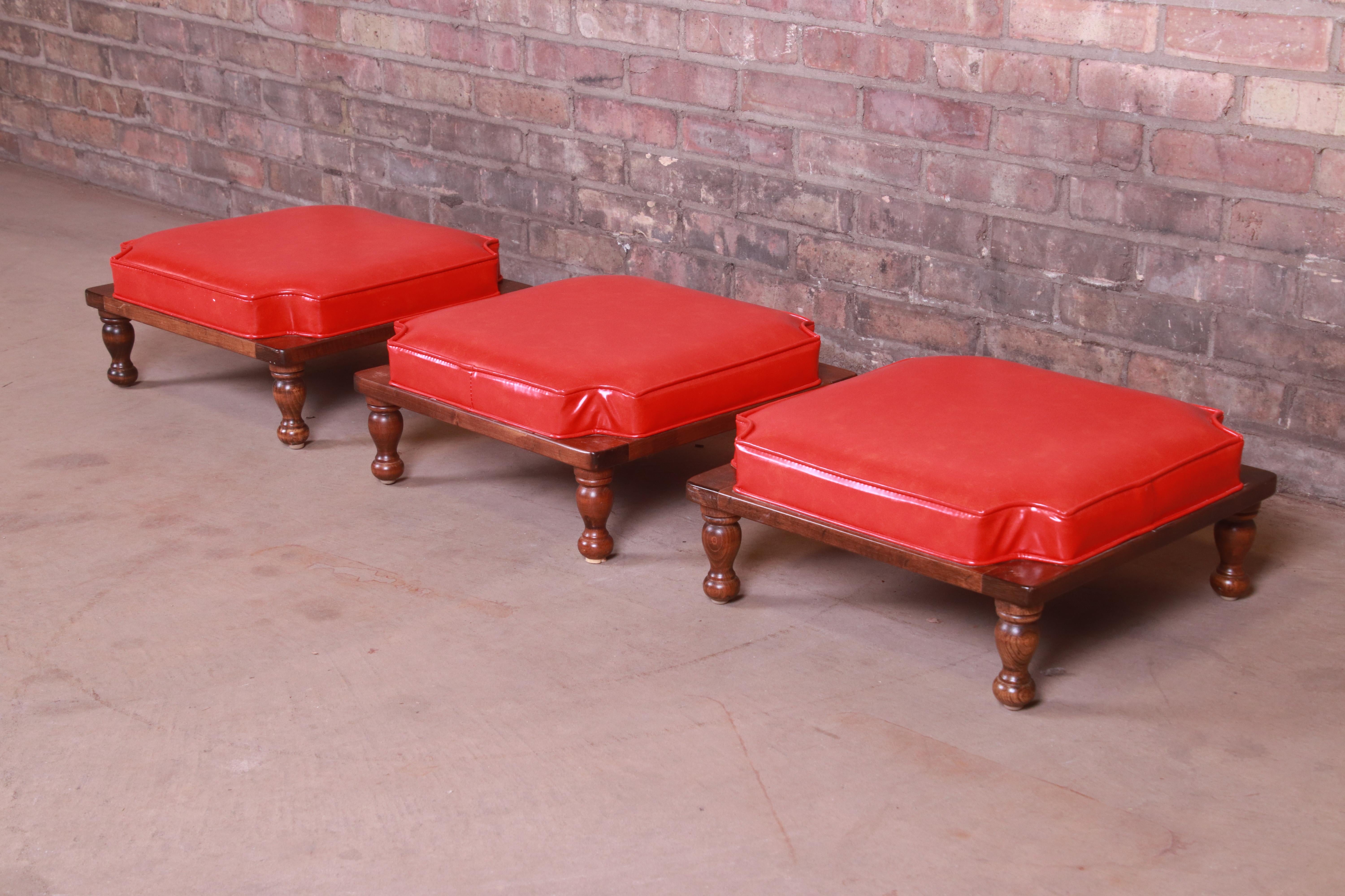 A gorgeous set of three stacking ottomans or stools

By Ethan Allen

USA, circa 1970s

Solid carved maple, with original red vinyl upholstery.

Measures: 16.75