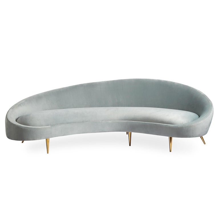 Heaven sent. A curved sofa announces to the world that you are on the varsity decorating squad. Airy yet edgy, our Ether Curved sofa is upholstered in heavenly Bergamo Azure velvet and perched on polished brass stiletto legs.

More than a pretty