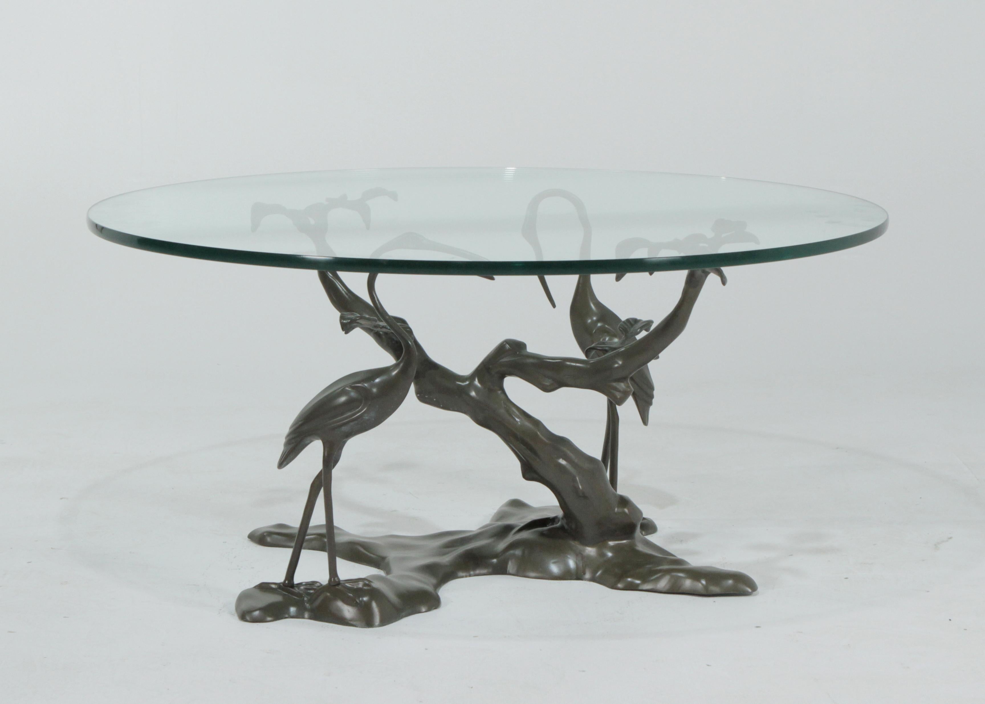 A sculptural coffee table base in the manner of Willy Daro. The original green patina is in good condition with some color variations. The glass is only shown for photographic purposes and is not included in the sale. We suggest 36 inch 1/2 inch