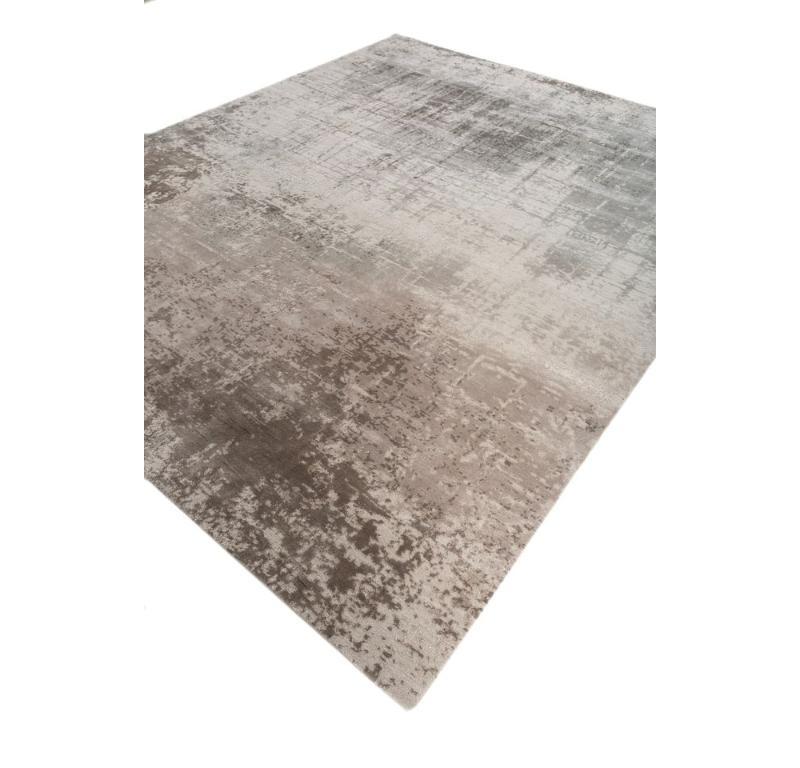 What whispers of tranquility lie within the delicate embrace of this handknotted rug from the collection - Tattvam by Gauri Khan? Envision a canvas of white sand where the essence of rural India dances in timeless elegance. Hand-knotted with
