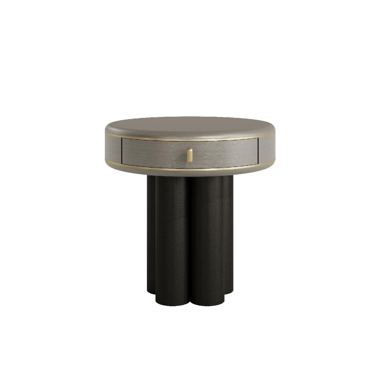 The Ethereal bedside table exudes sophisticated luxury with its graceful design. 

With a round top and cylindrical legs, this piece can be finished in lacquered or wood, providing versatility for different decor styles. Inspired by natural forms,