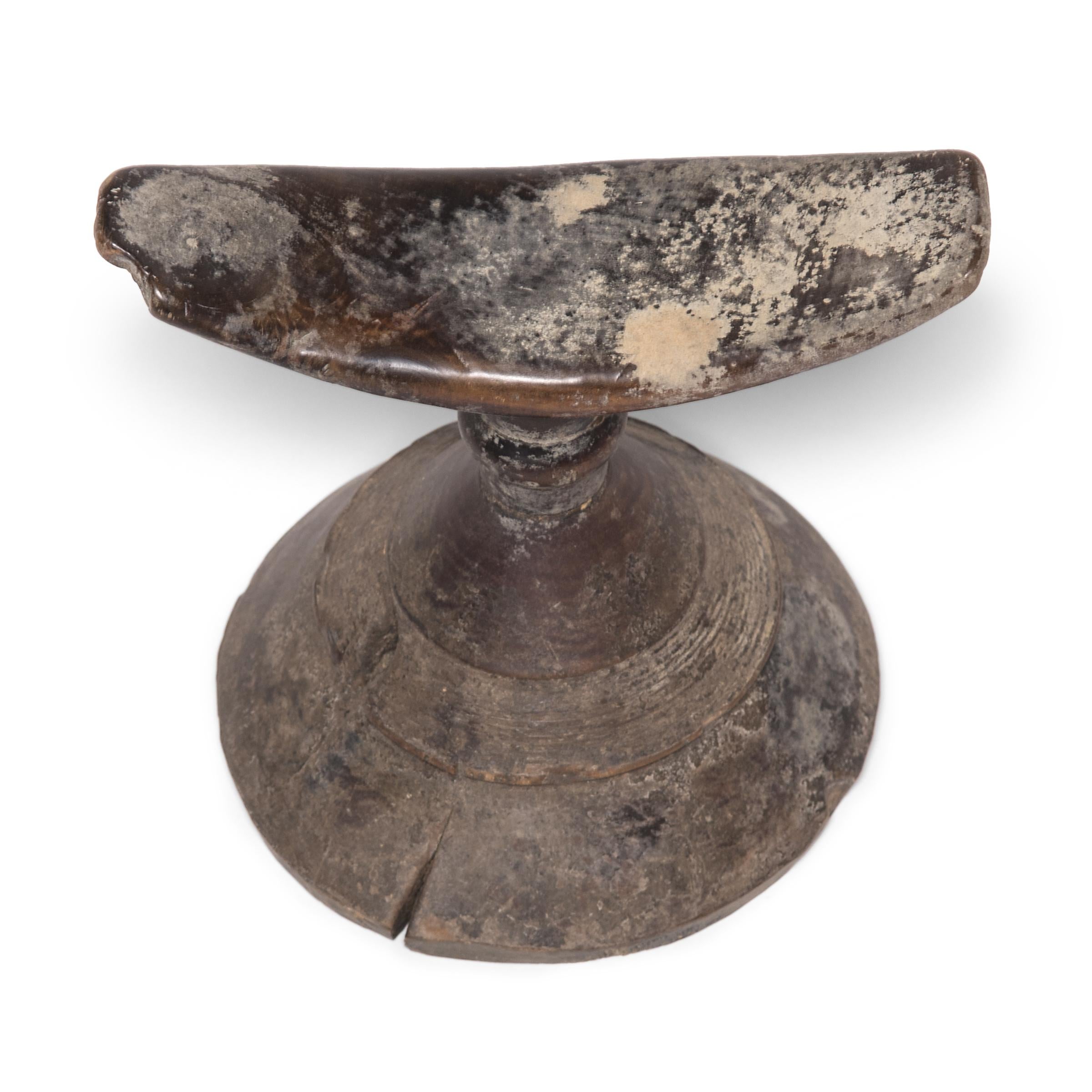 So as not to muss their intricate hairstyles, Ethiopian women would traditionally rest their heads on these petite wooden stands. The combination of conic base and concave rest gives this functional item an elevated sense of artistry. Expressively