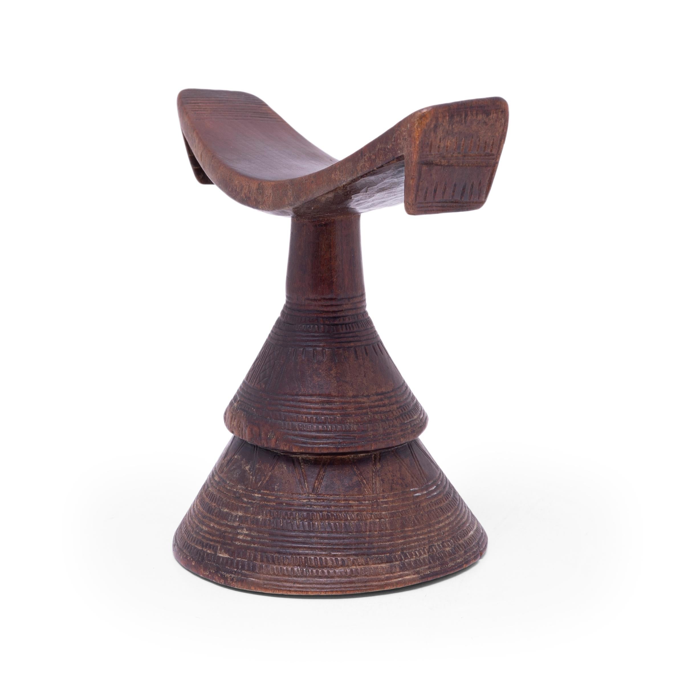 So as not to muss their intricate hairstyles while sleeping, Ethiopian women would traditionally rest their heads on these petite wooden stands. The combination of conic base and concave rest gives this functional item an elevated sense of artistry.